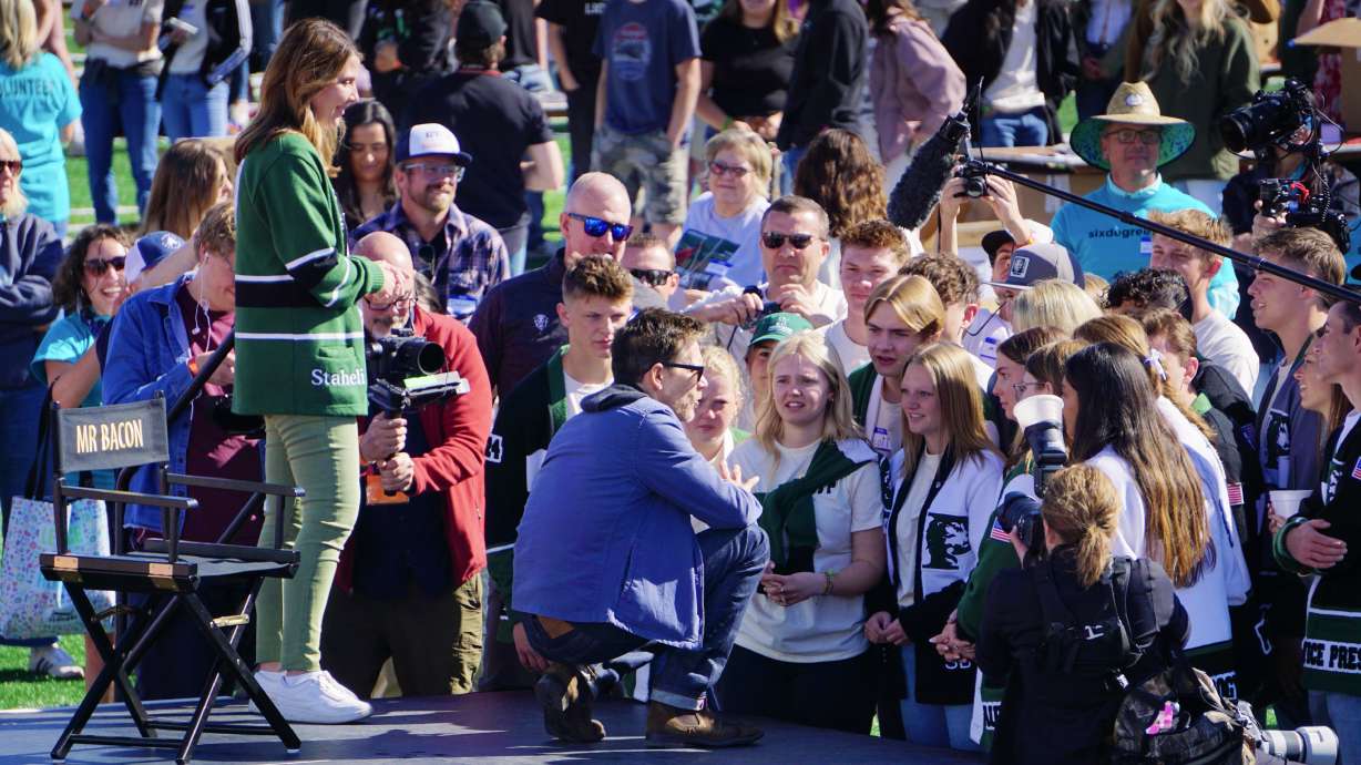 Kevin Bacon speaks to Payson High School students on the school's football field, before volunteers began building care packages for local nonprofits with Bacon’s charity Six Degrees in Payson on Saturday.