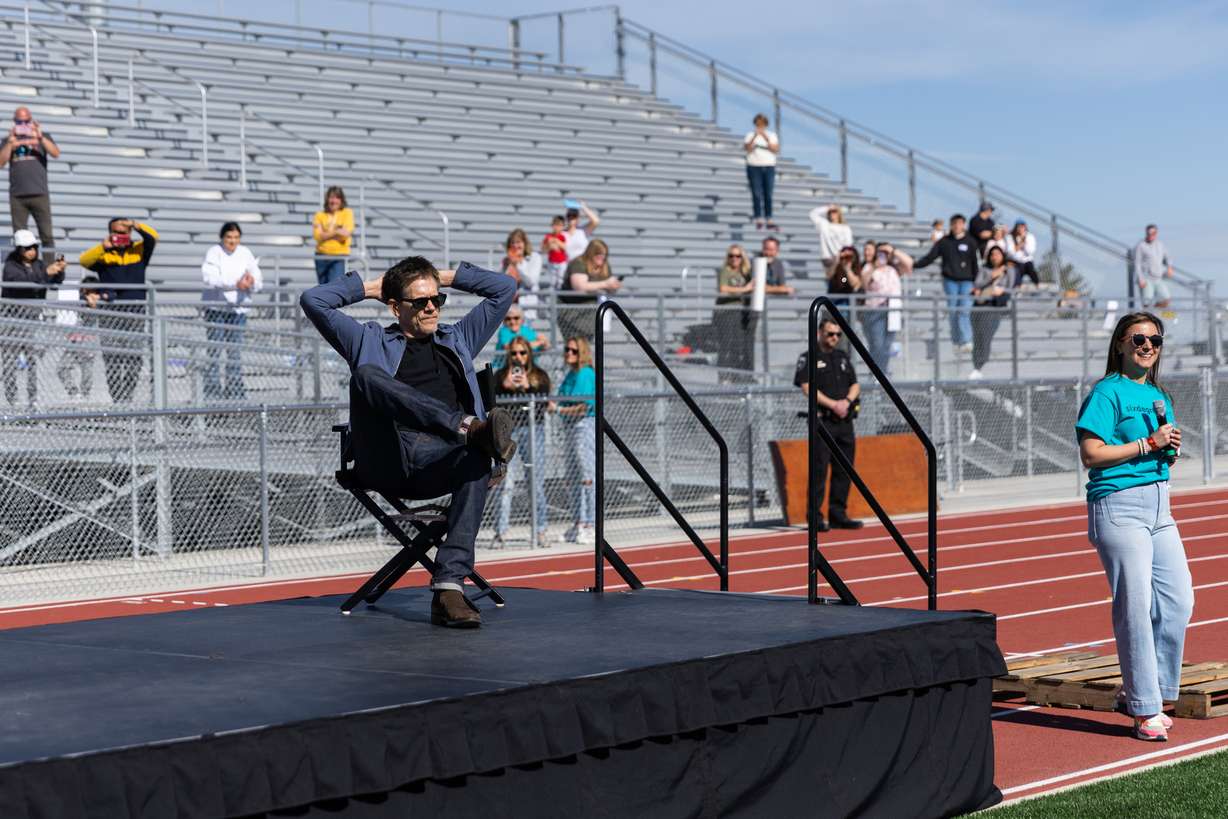 Kevin Bacon sits in a chair gifted to him by students after giving remarks at Payson High School and partaking in a community kit-building program with Bacon’s charity Six Degrees in Payson on Saturday.