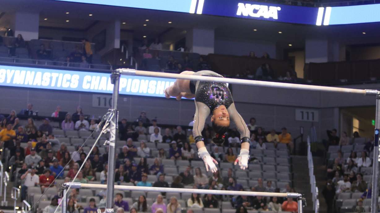Utah gymnast Amelie Morgan moves from the low to high bar in the NCAA national championship meet in Fort Worth, Texas, on April 20, 2024.