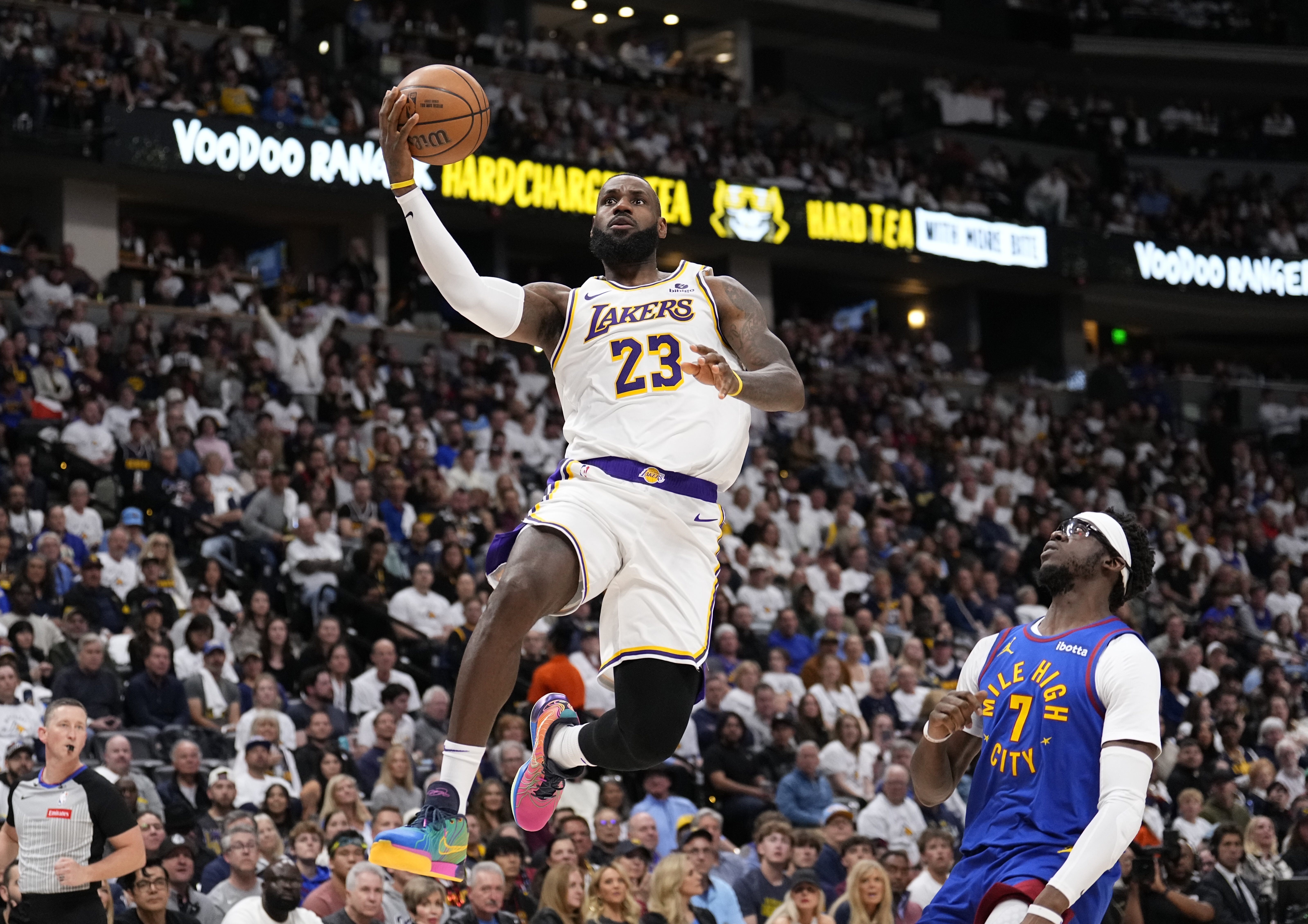 Los Angeles Lakers forward LeBron James (23) goes up to shoot against Denver Nuggets guard Reggie Jackson (7) during the first half in Game 1 of an NBA basketball first-round playoff series Saturday, April 20, 2024, in Denver. 