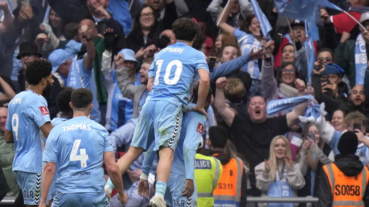 Coventry City players celebrate after scoring during the English FA Cup semifinal soccer match between Coventry City and Manchester United at Wembley stadium in London, Sunday, April 21, 2024.