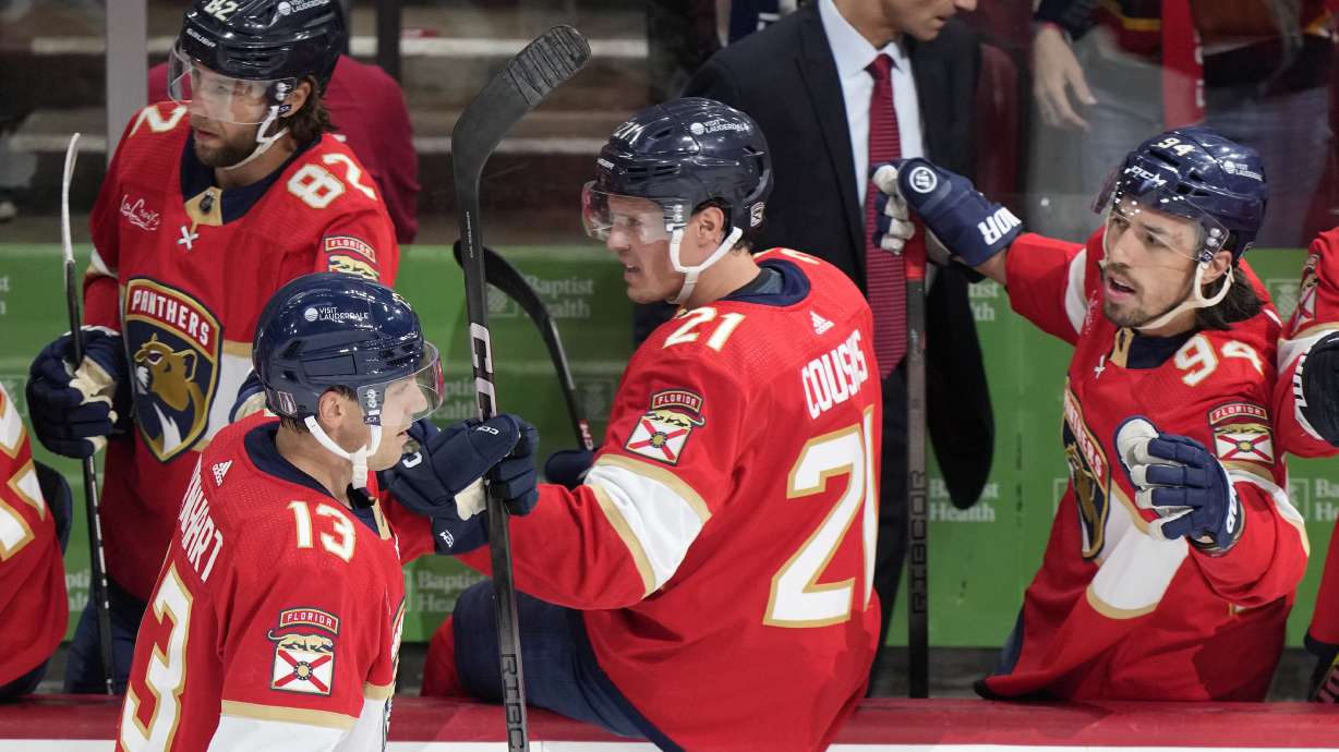 Florida Panthers center Sam Reinhart (13) is congratulated by teammates after he scored during the first period of Game 1 of the first-round of an NHL Stanley Cup Playoff series against the Tampa Bay Lightning, Sunday, April 21, 2024, in Sunrise, Fla.