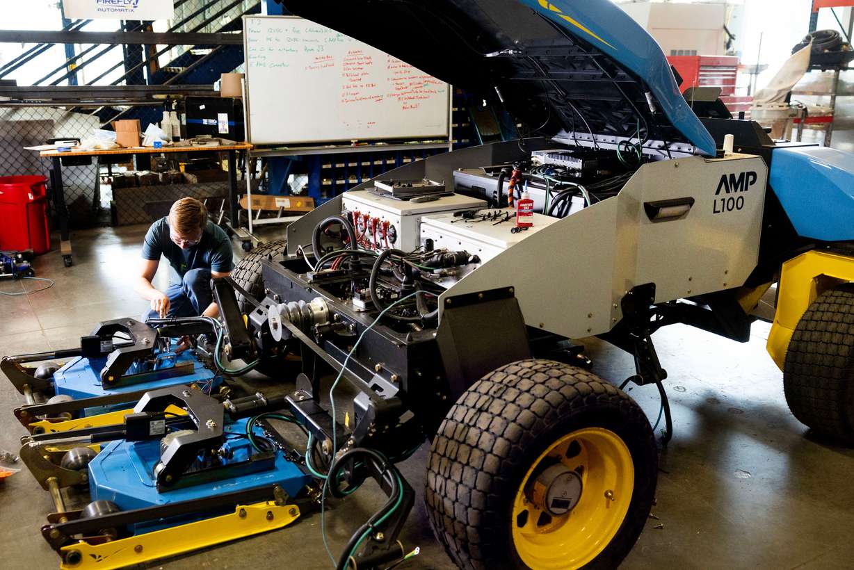 Tanner Dixon, mechanical engineer, works on the cutting unit of a fully autonomous lawn mower at FireFly Automatix in Salt Lake City on March 13.