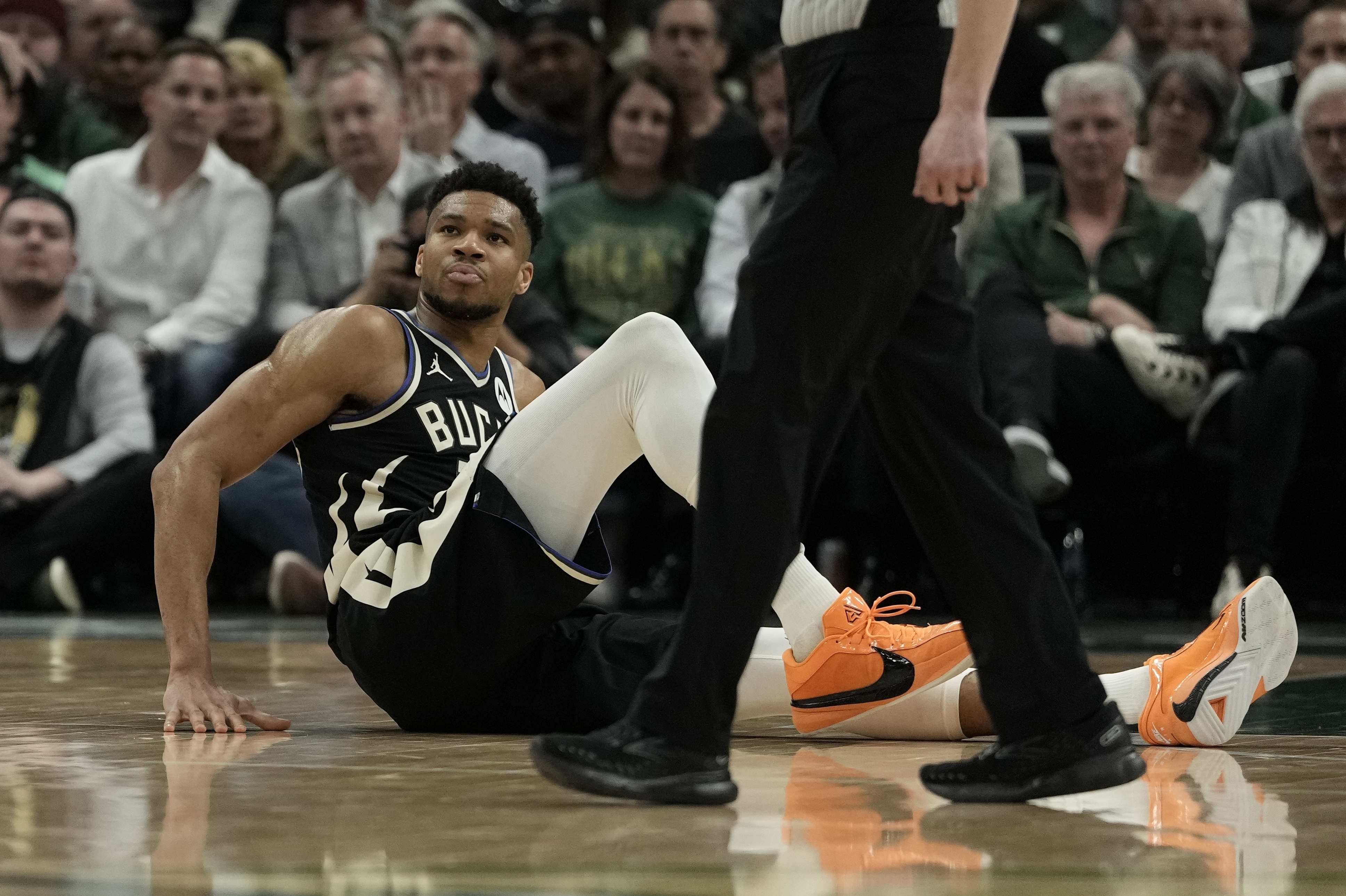 Milwaukee Bucks' Giannis Antetokounmpo sits on the court during the second half of an NBA basketball game against the Boston Celtics Tuesday, April 9, 2024, in Milwaukee. Giannis Antetokounmpo left the game. The Bucks won 104-91. 