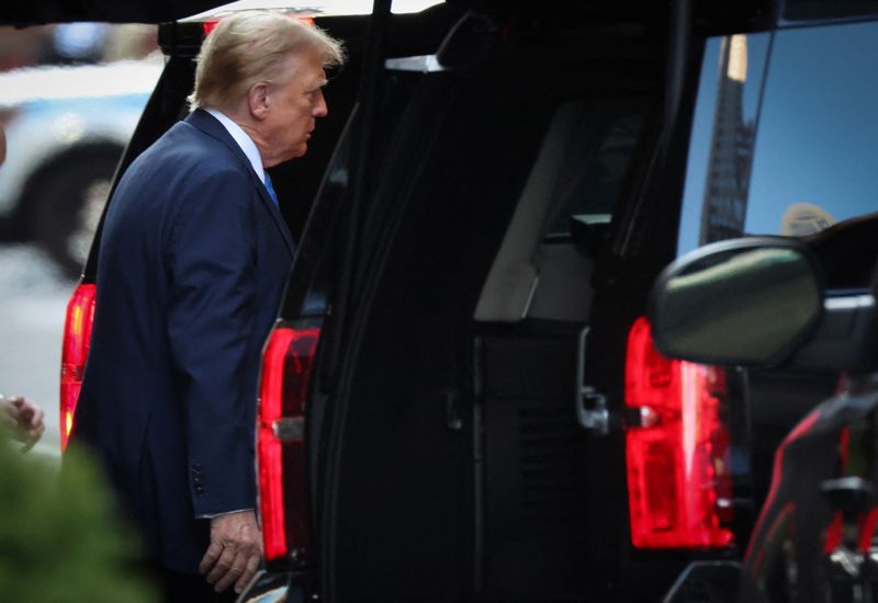 Republican presidential candidate and former president Donald Trump departs Trump tower in Manhattan to attend his criminal trial over charges that he falsified business records to conceal money paid to silence porn star Stormy Daniels in 2016, in New York City, Monday.