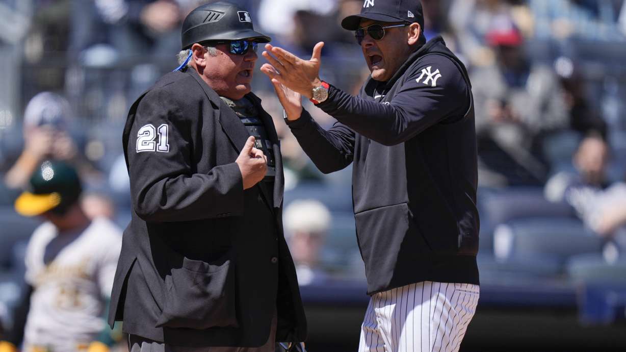 New York Yankees manager Aaron Boone, right, argues with umpire Hunter Wendelstedt during the first inning of the baseball game against the Oakland Athletics at Yankee Stadium Monday, April 22, 2024, in New York. Boone was ejected from the game.
