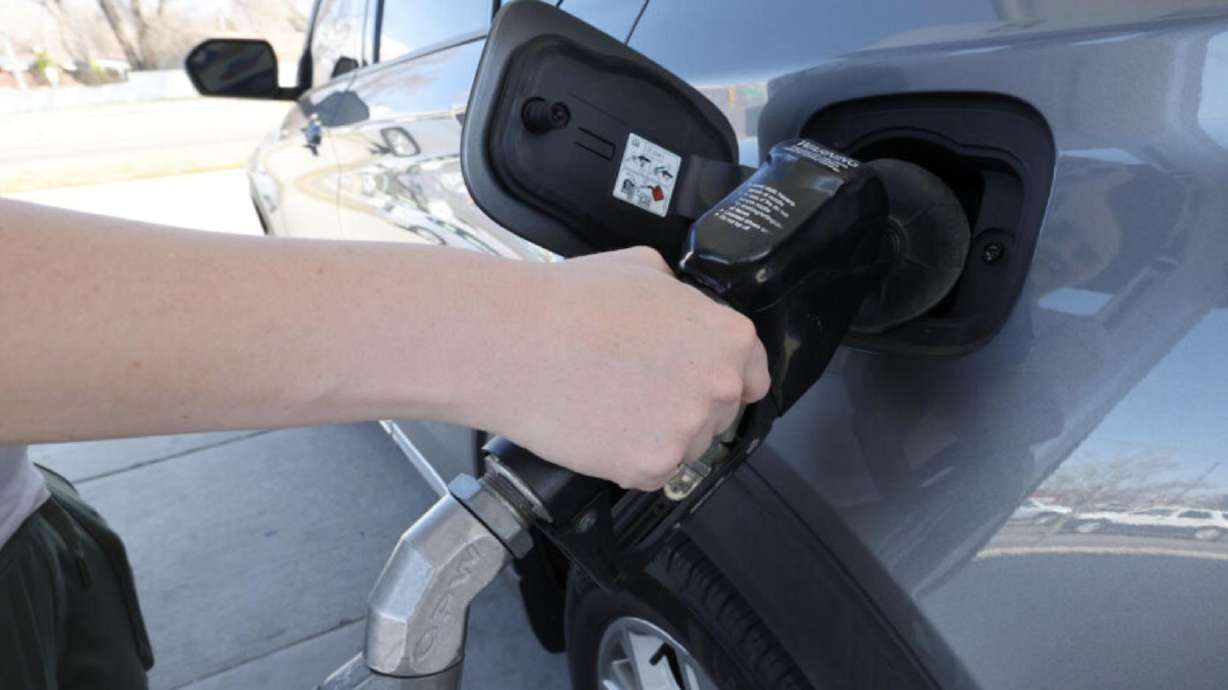 A car is filled at a gas pump in Sandy on March 19. Hurricane season could affect gas prices.