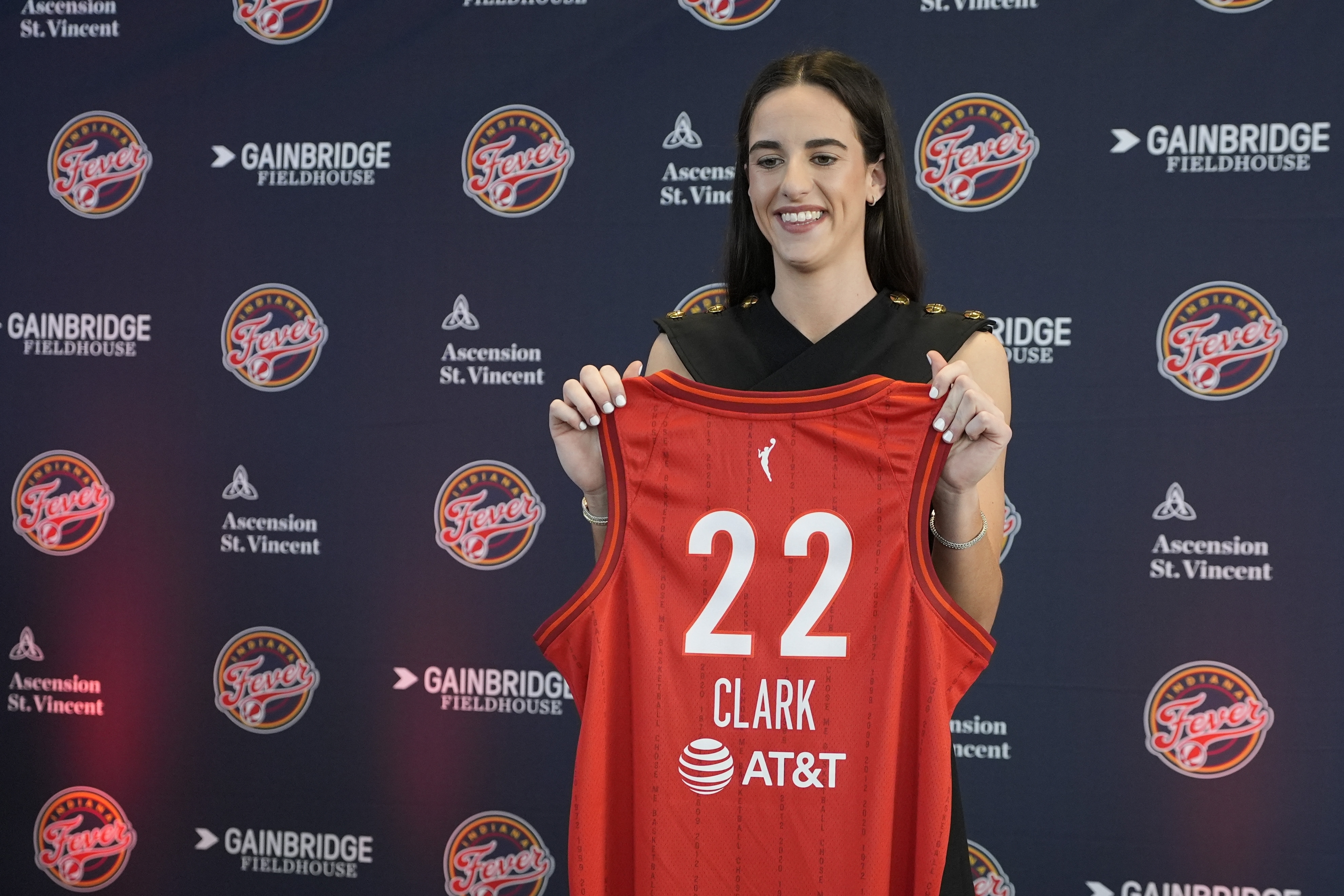 Indiana Fever's Caitlin Clark holds her jersey following a WNBA basketball news conference, Wednesday, April 17, 2024, in Indianapolis.