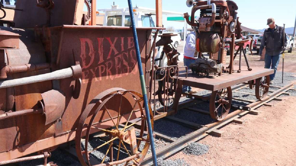 Workers help with the installation of "Dixie Express" train sculpture by artist Matt Clark, in Enterprise, Friday.