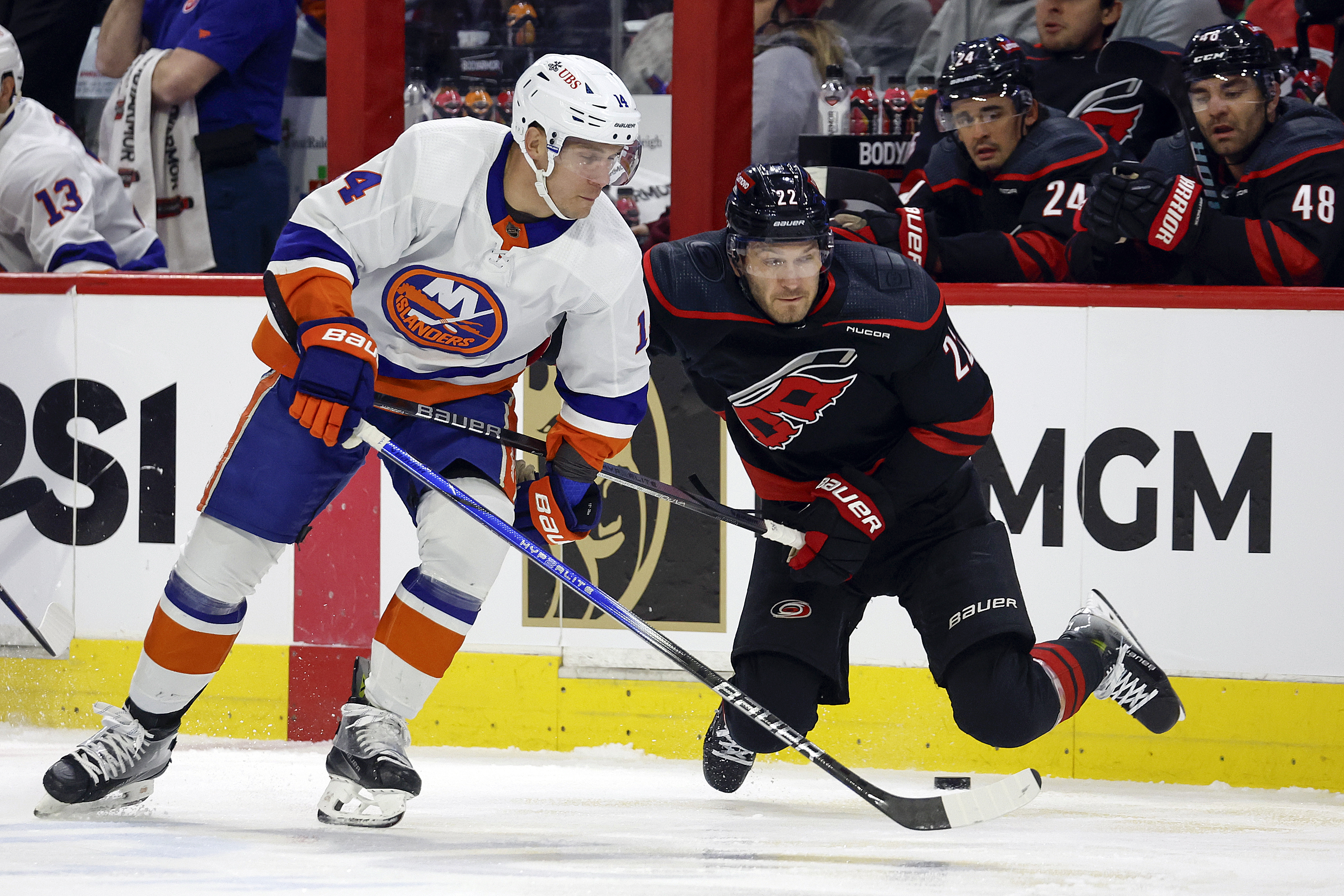 New York Islanders' Bo Horvat (14) collides with Carolina Hurricanes' Brett Pesce (22) during the first period in Game 2 of an NHL hockey Stanley Cup first-round playoff series in Raleigh, N.C., Monday, April 22, 2024.