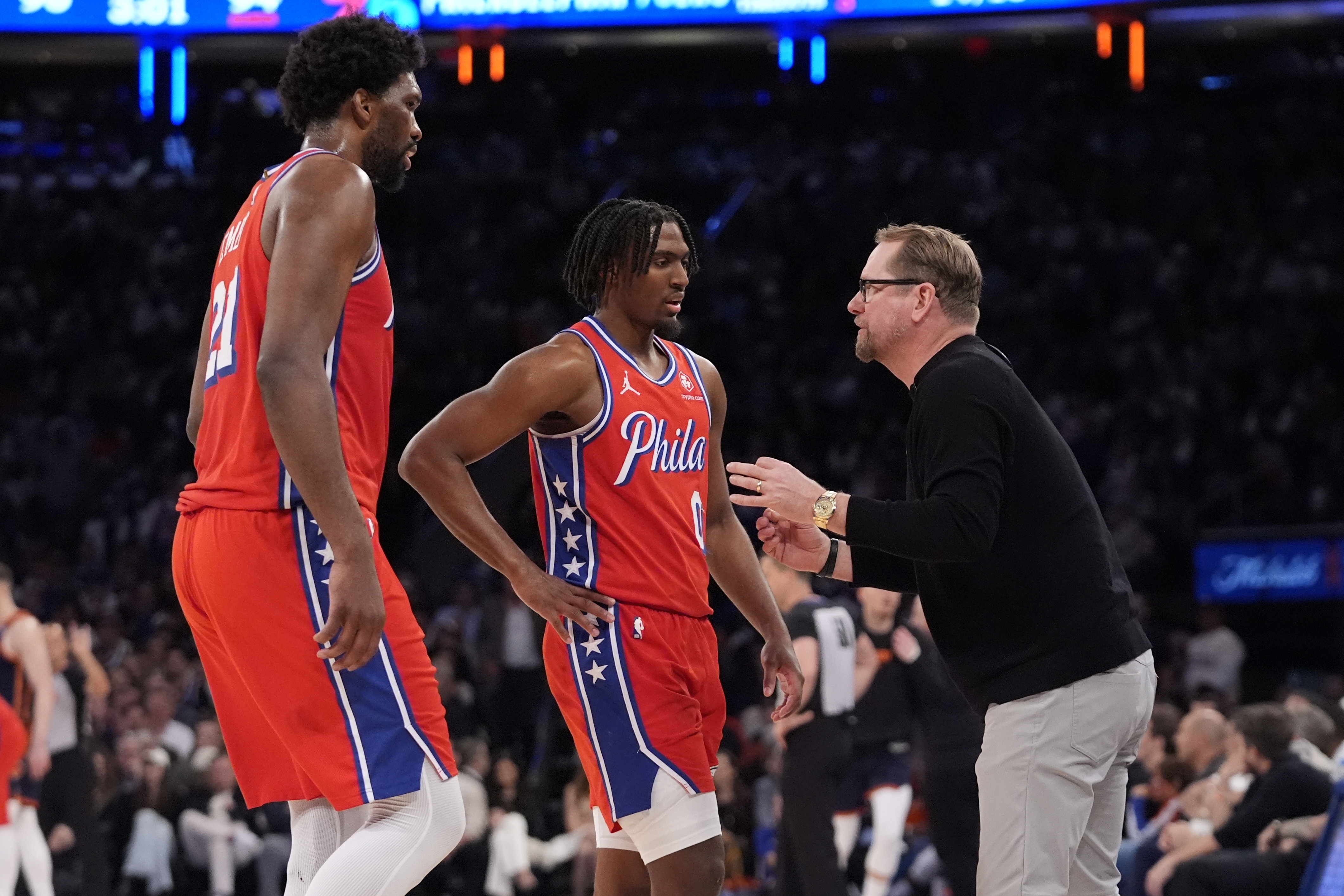 Philadelphia 76ers head coach Nick Nurse, right, talks to Tyrese Maxey, center, and Joel Embiid, left, during the second half of Game 2 in an NBA basketball first-round playoff series against the New York Knicks, Monday, April 22, 2024, in New York.