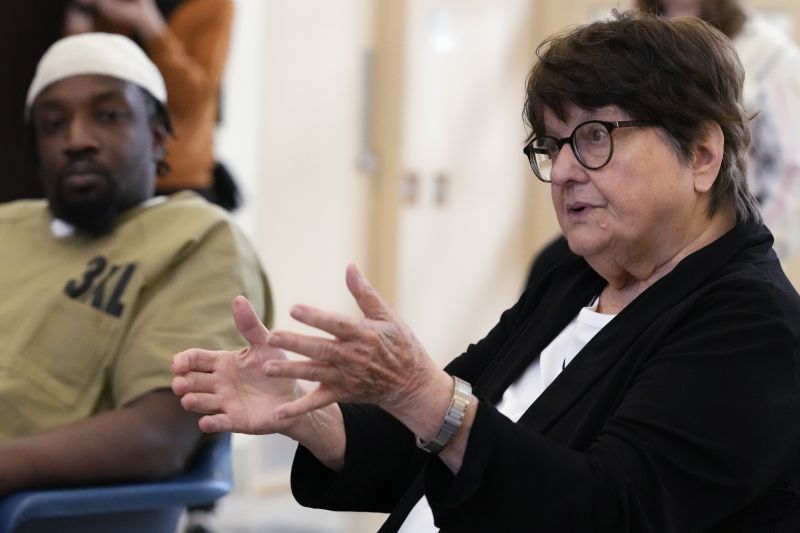 Sister Helen Prejean, right, talks during a book club as detainee listens at Department Of Corrections Division 11 in Chicago, Monday.