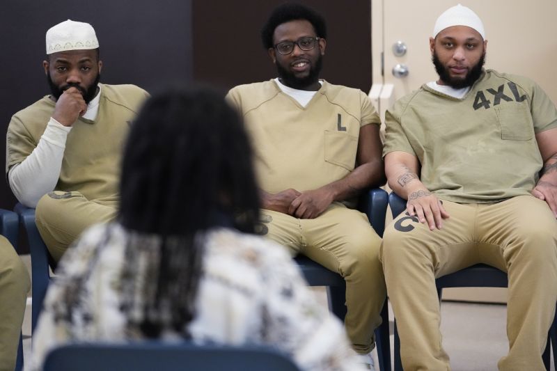 Detainees listen to Seven Clark during a book club at Department Of Corrections Division 11 in Chicago, Monday.