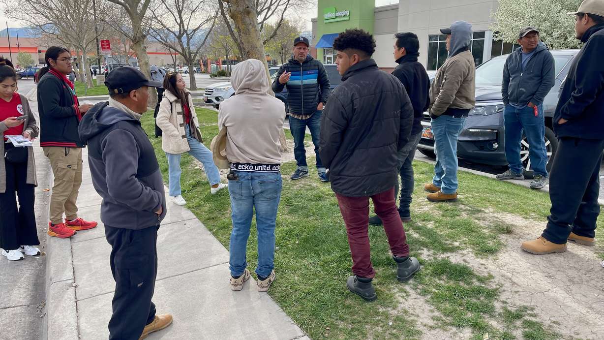 Luis Valentan of the National Day Laborer Organizing Network, center, speaks with day laborers outside Home Depot in West Valley City on Friday. Also present were organizers from Comunidades Unidas, an immigrant advocacy group.