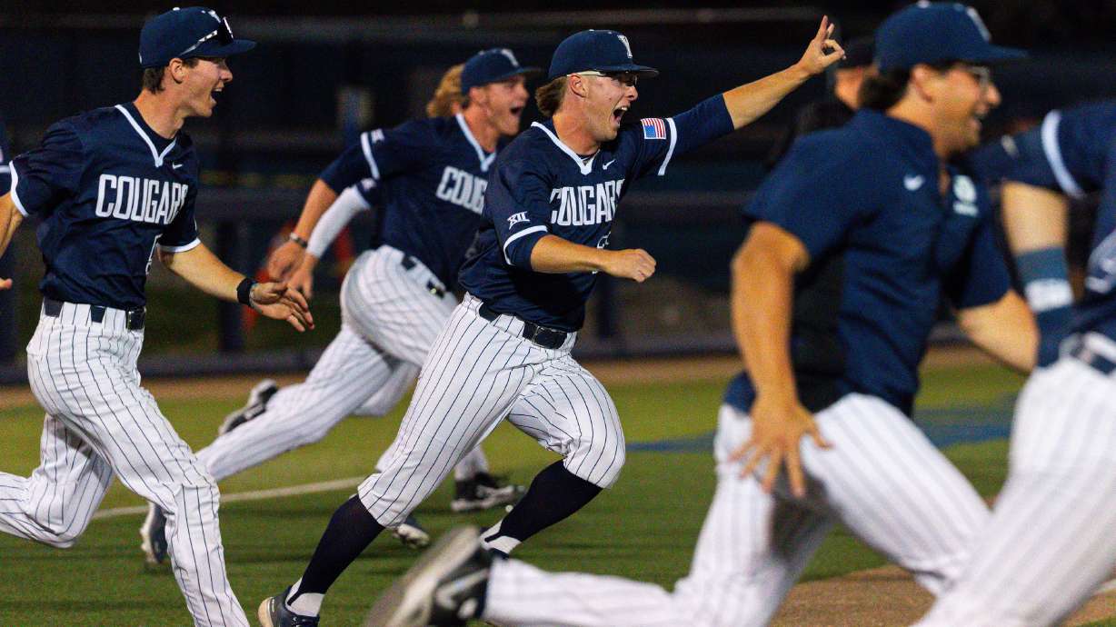 Brigham Young Cougars players run onto the field after their win against the Utah Utes in a college baseball game at Miller Park Complex in Provo on Tuesday, April 23, 2024.