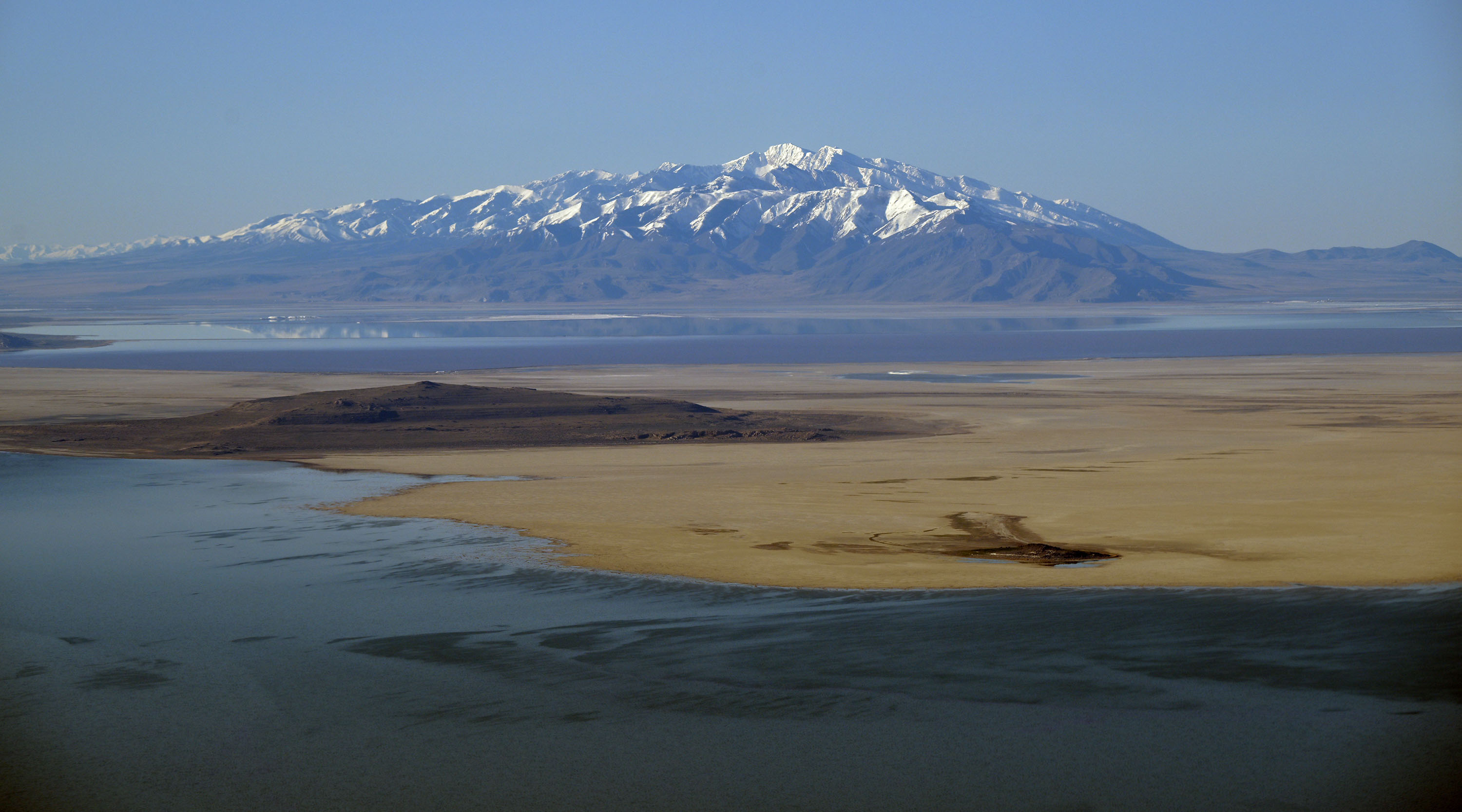A snow-covered mountain peak is seen from a flight over the Great Salt Lake on April 9. About two-thirds of the Great Salt Lake Basin's snowpack has yet to melt, as of Wednesday.