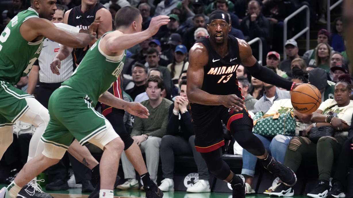 Miami Heat center Bam Adebayo, right, drives to the basket against the Boston Celtics during the second half of Game 2 of an NBA basketball first-round playoff series, Wednesday, April 24, 2024, in Boston.