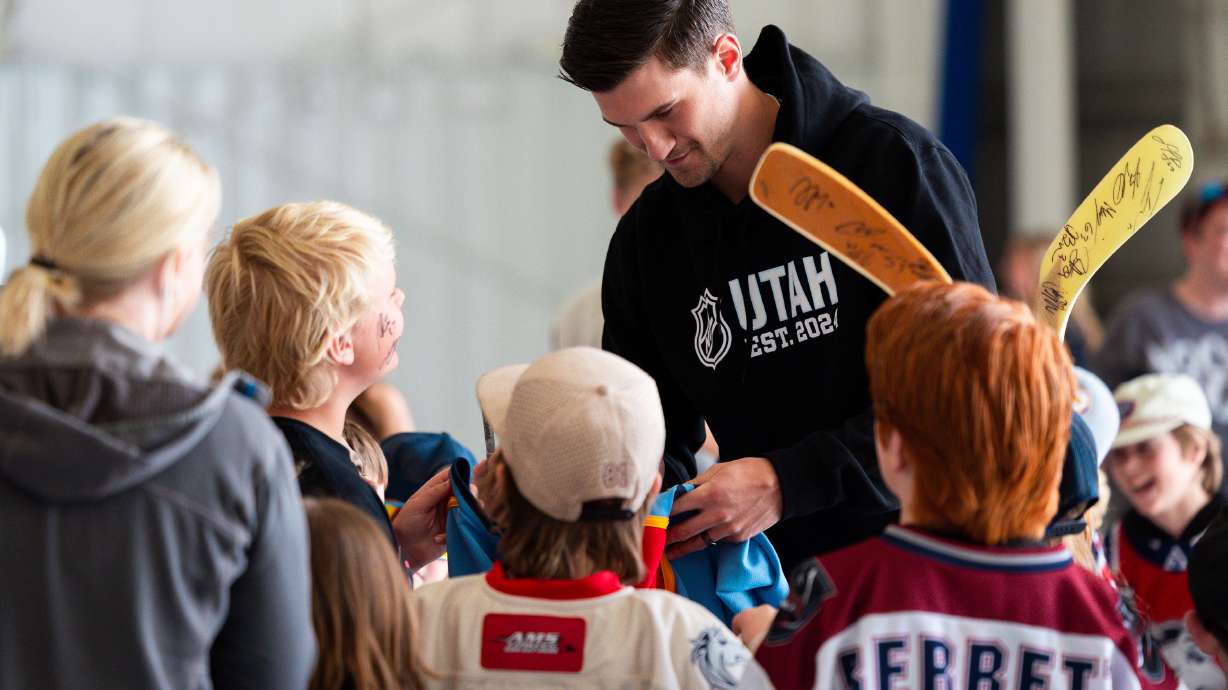 Jack McBain, member of the new Utah National Hockey League team, signs autographs for a crowd made up of youth from local hockey programs that greets the team upon their arrival at Signature Aviation SLC in Salt Lake City on Wednesday, April 24, 2024.