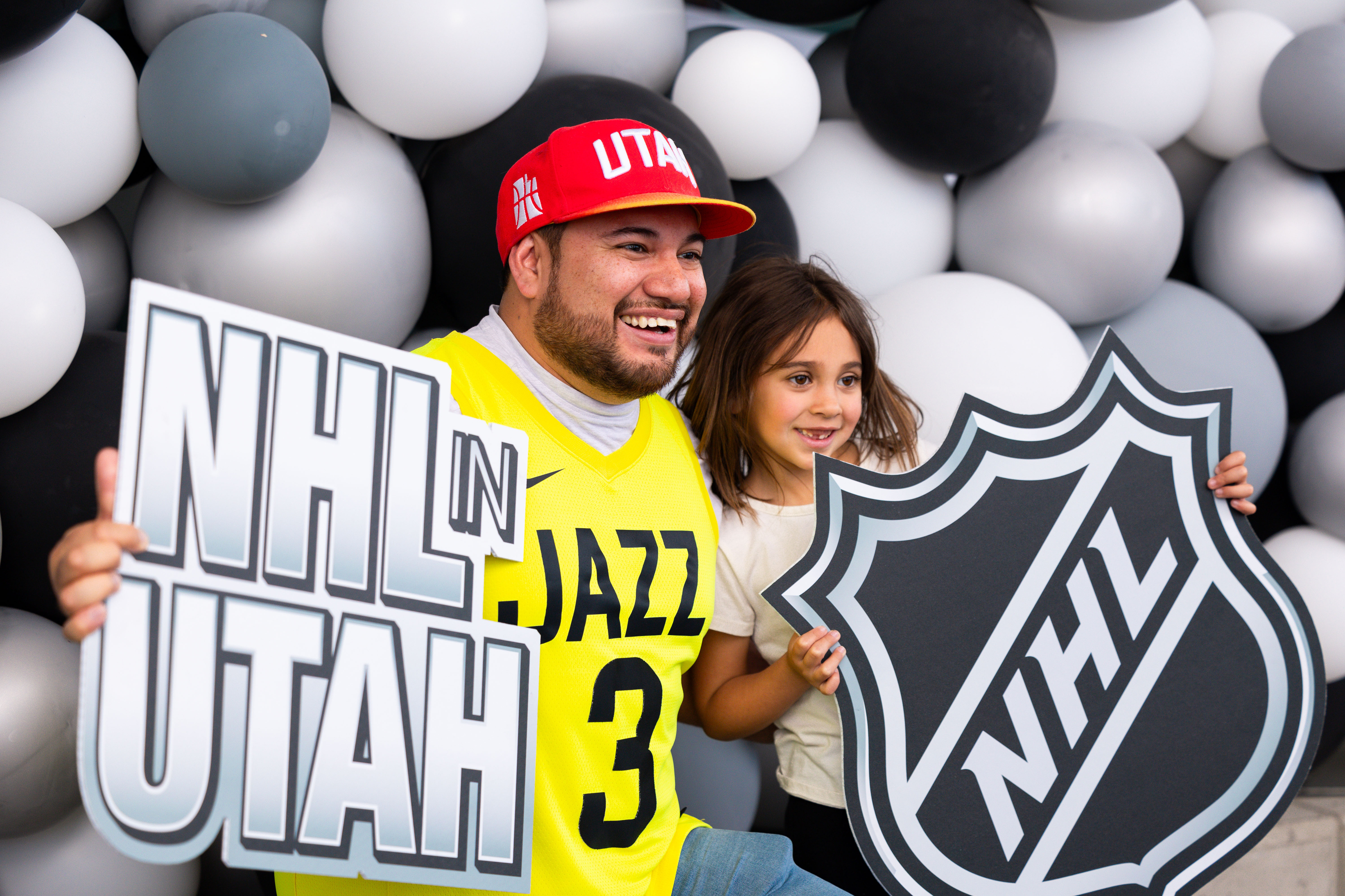 EJ and Ellie Ayala hold NHL signs in a photo booth at an event held to celebrate Utah’s new NHL team at the Delta Center in Salt Lake City on Wednesday, April 24, 2024.