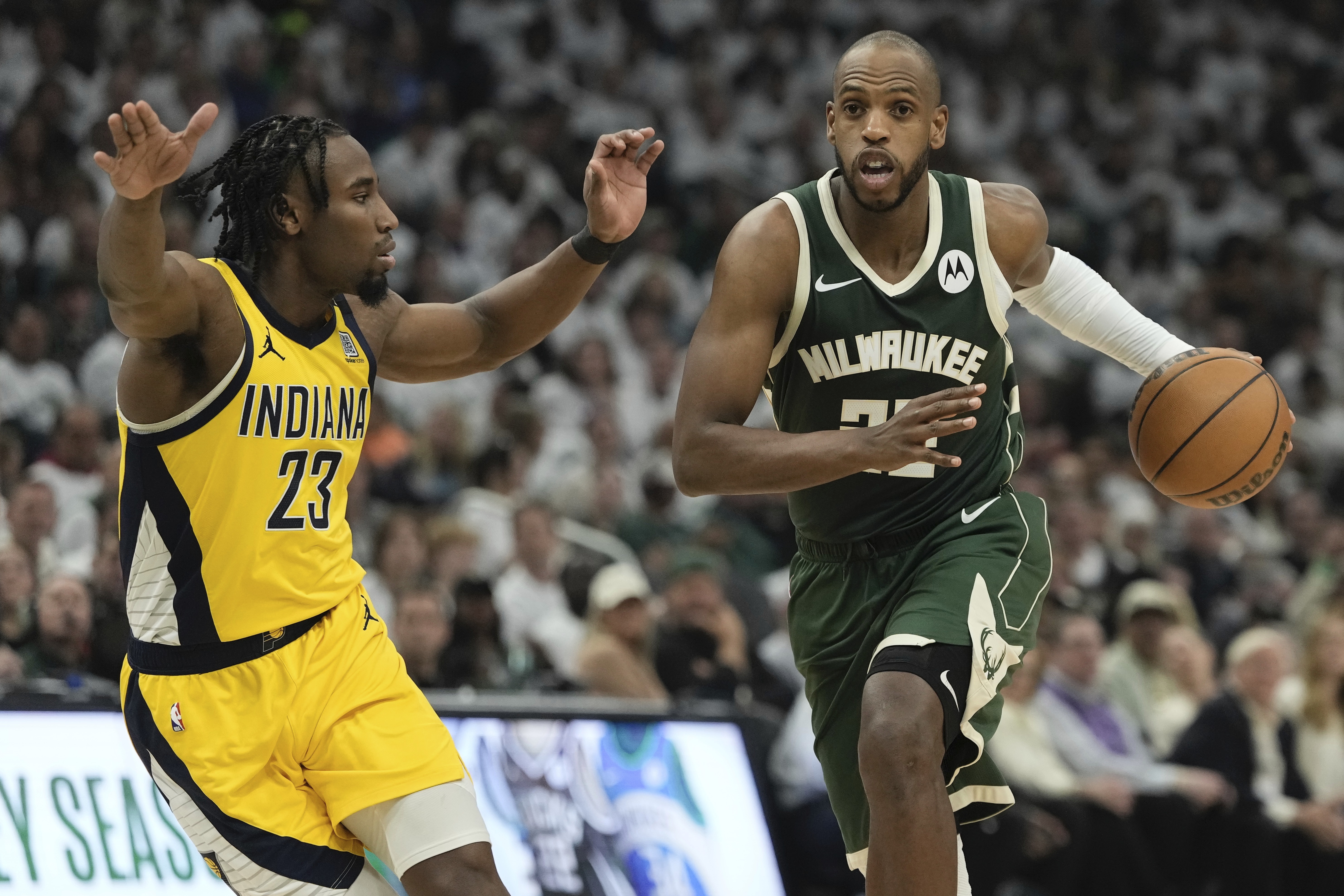 Milwaukee Bucks' Khris Middleton gets past Indiana Pacers' Aaron Nesmith during the first half of Game 2 of the NBA playoff basketball game Tuesday, April 23, 2024, in Milwaukee.