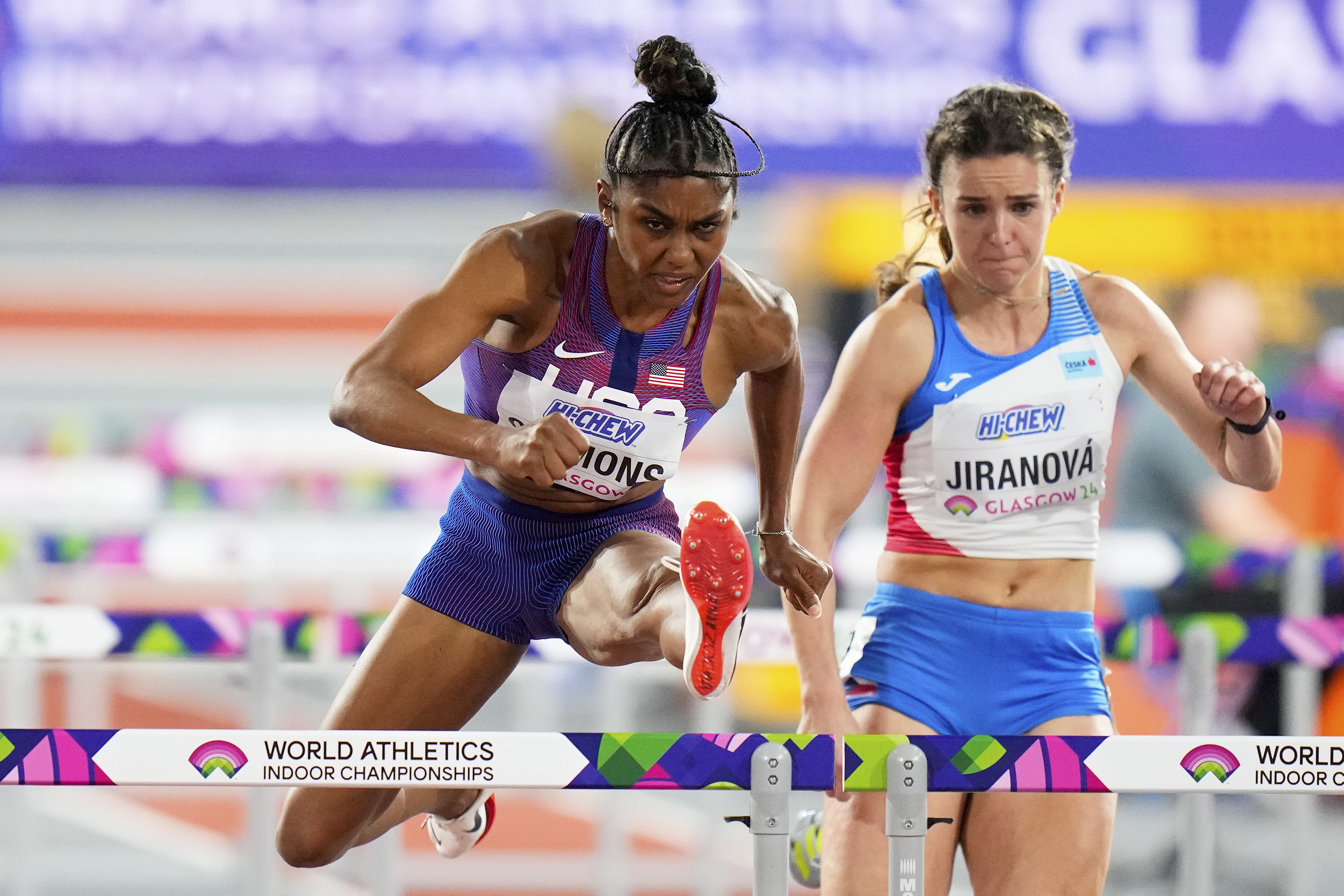 FILE - Christina Clemons, of the United States, and Helena Jiranova, of the Czech Republic, compete in a women's 60 meters hurdles heat during the World Athletics Indoor Championships at the Emirates Arena in Glasgow, Scotland, Sunday, March 3, 2024. U.S. Olympic hurdler Christina Clemons sent email after email raising concerns over a gap in health-care insurance coverage for new mothers who still wanted to compete. Those baby steps turned into big strides as USA Track and Field unveiled a program Thursday, April 25, that expands an existing maternity support system to give new moms even more time to return to an elite level. 