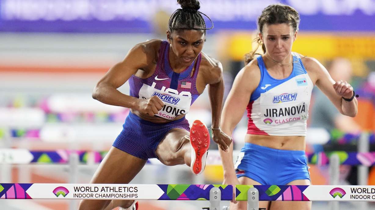 FILE - Christina Clemons, of the United States, and Helena Jiranova, of the Czech Republic, compete in a women's 60 meters hurdles heat during the World Athletics Indoor Championships at the Emirates Arena in Glasgow, Scotland, Sunday, March 3, 2024. U.S. Olympic hurdler Christina Clemons sent email after email raising concerns over a gap in health-care insurance coverage for new mothers who still wanted to compete. Those baby steps turned into big strides as USA Track and Field unveiled a program Thursday, April 25, that expands an existing maternity support system to give new moms even more time to return to an elite level.
