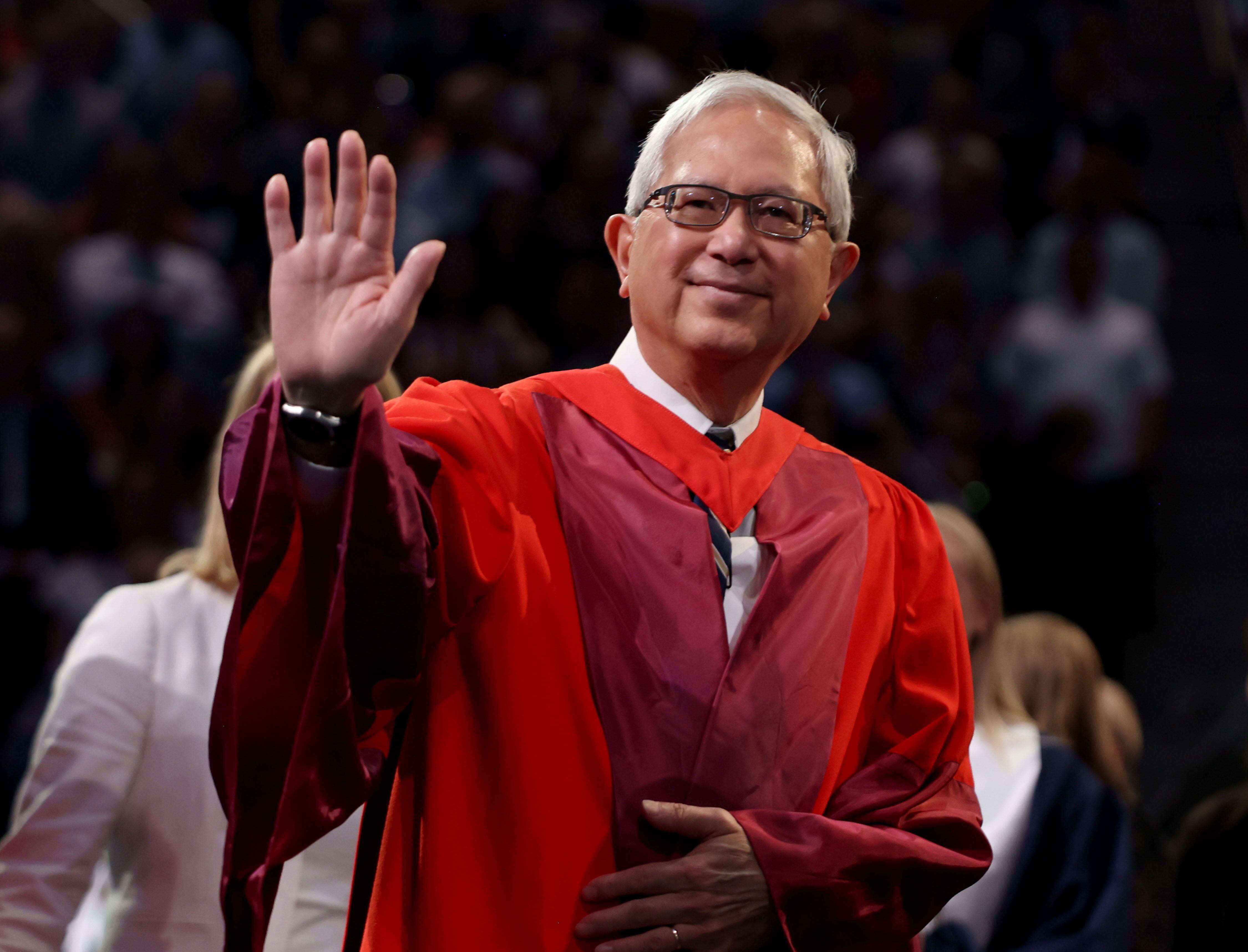 Elder Gerrit W. Gong of the Quorum of the Twelve Apostles of The Church of Jesus Christ of Latter-day Saints waves to students at the BYU commencement ceremony in the Marriott Center in Provo on Thursday.