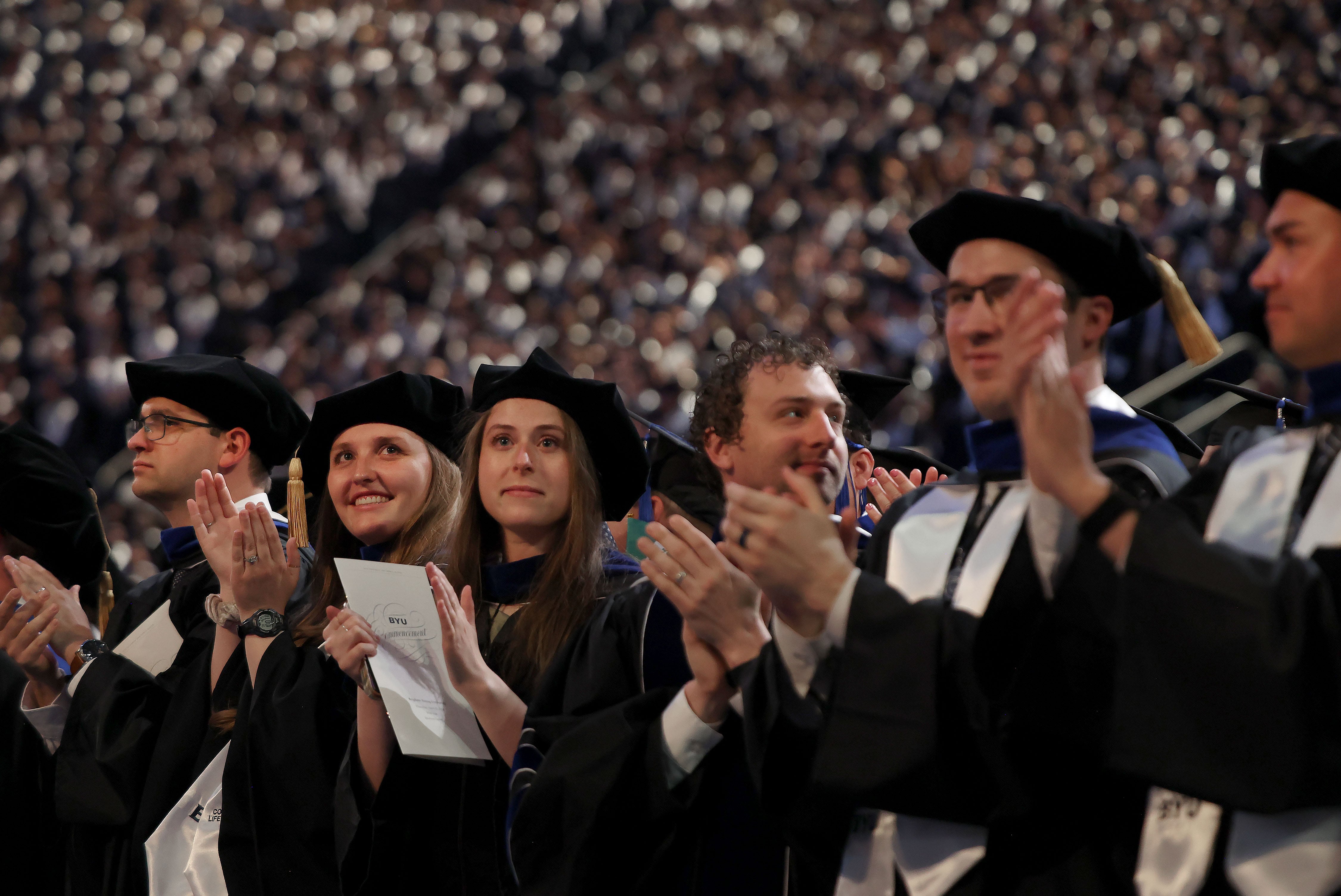 Doctoral graduates applaud during the BYU commencement ceremony at the Marriott Center in Provo on Thursday.