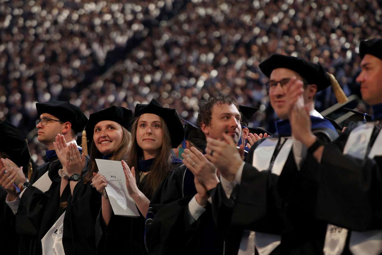 Doctoral graduates applaud during the BYU commencement ceremony at the Marriott Center in Provo on Thursday.