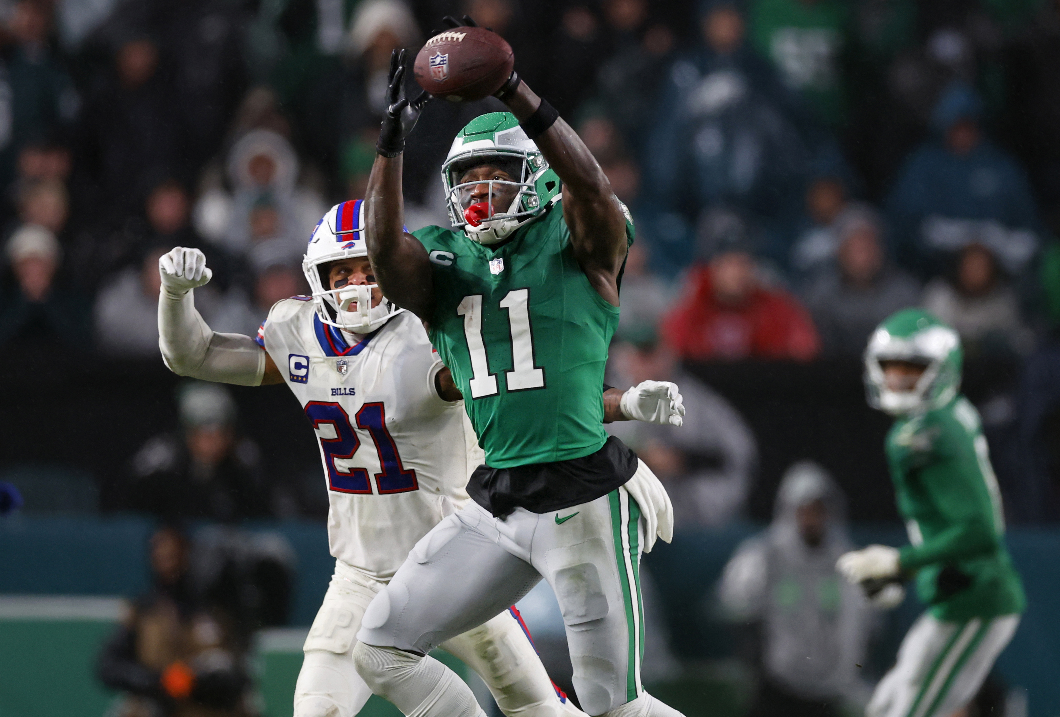 FILE - Philadelphia Eagles wide receiver A.J. Brown (11) makes a catch as Buffalo Bills safety Jordan Poyer (21) defends during an NFL football game Nov. 26, 2023, in Philadelphia. The Eagles and Brown have agreed to a three-year contract extension.