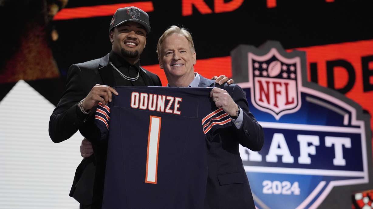 Washington wide receiver Rome Odunze, left, poses with NFL Commissioner Roger Goodell after being chosen by the Chicago Bears with the ninth overall pick during the first round of the NFL football draft, Thursday in Detroit.