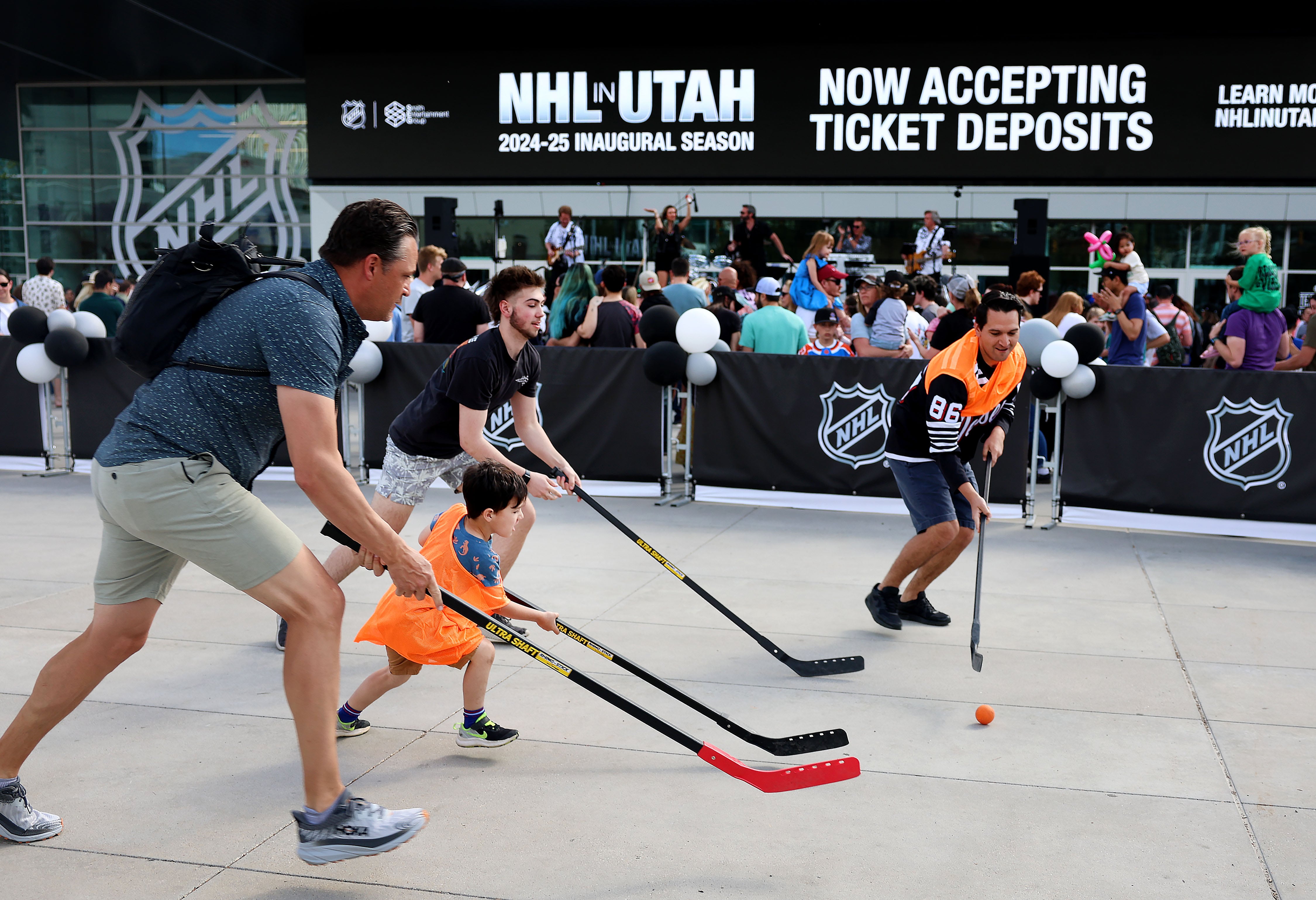 People play street hockey during the NHL welcome party at the Delta Center in Salt Lake City on April 24.