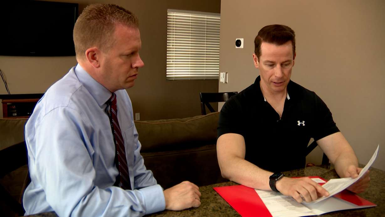 Rob Simpson, right, speaks to KSL-TV reporter Daniel Woodruff about the rising costs of insurance.