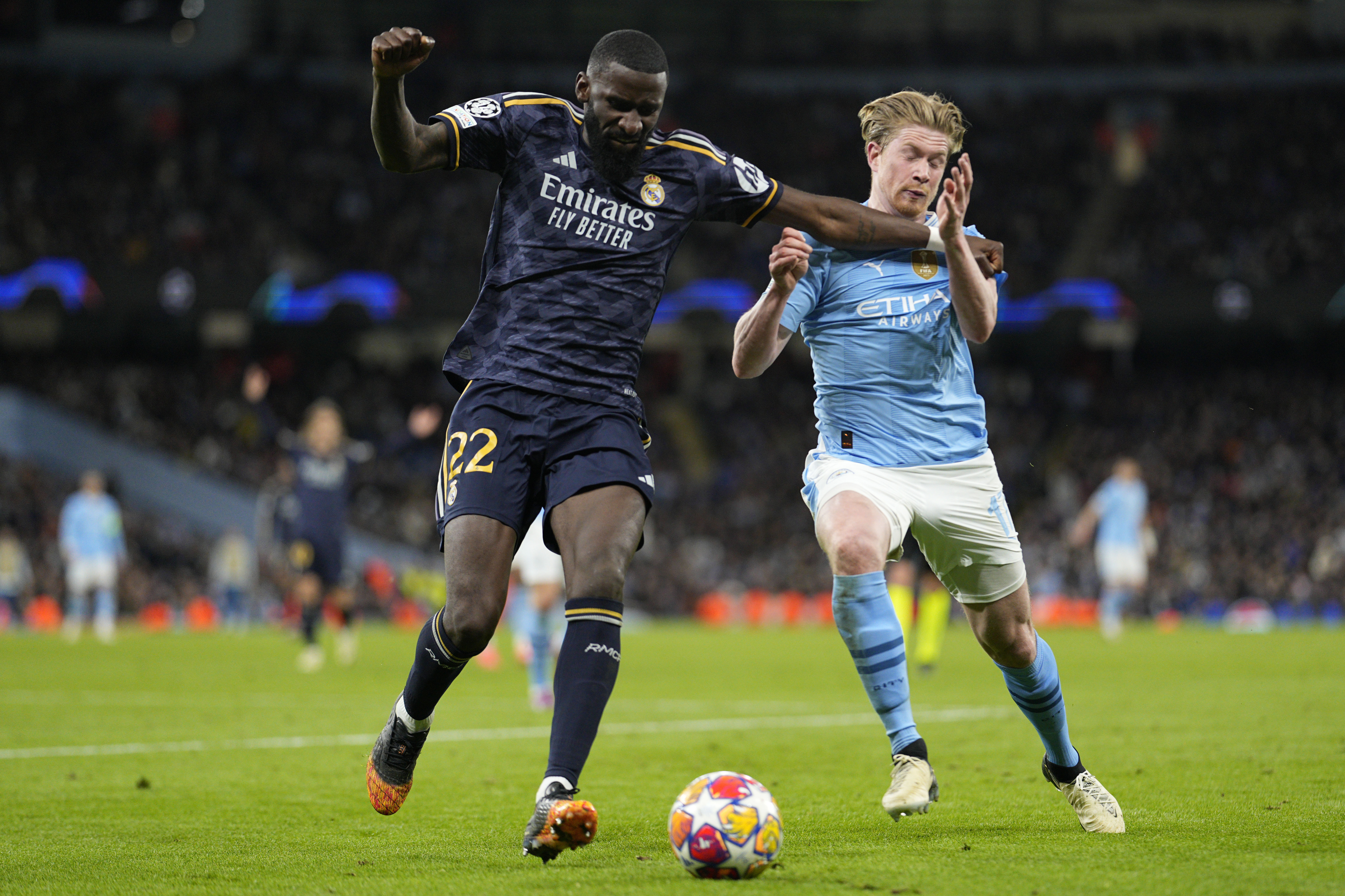 Manchester City's Kevin De Bruyne, right, fights for the ball with Real Madrid's Antonio Rudiger during the Champions League quarterfinal second leg soccer match between Manchester City and Real Madrid at the Etihad Stadium in Manchester, England, Wednesday, April 17, 2024.