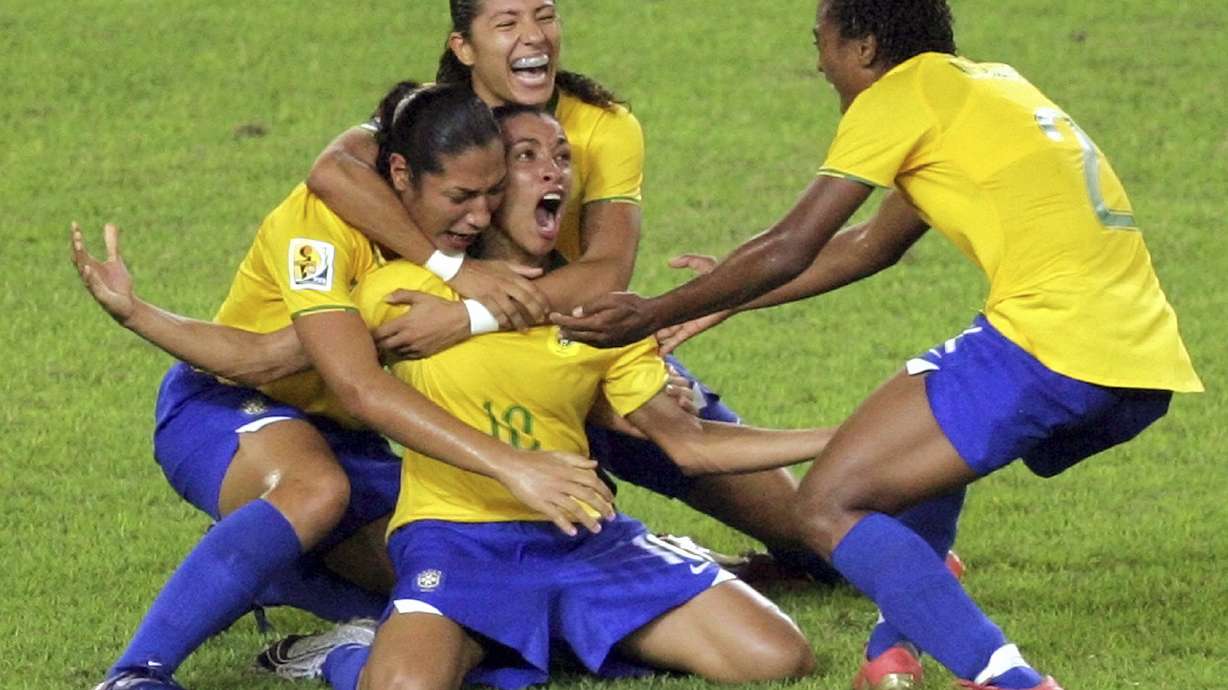 FILE - Brazil's Marta, center, celebrates her goal against the United States during a FIFA Women's World Cup semifinal soccer match in Hangzhou, China, Sept. 27, 2007. The six-time women's world player of the year plans to retire from the national team after 2024.