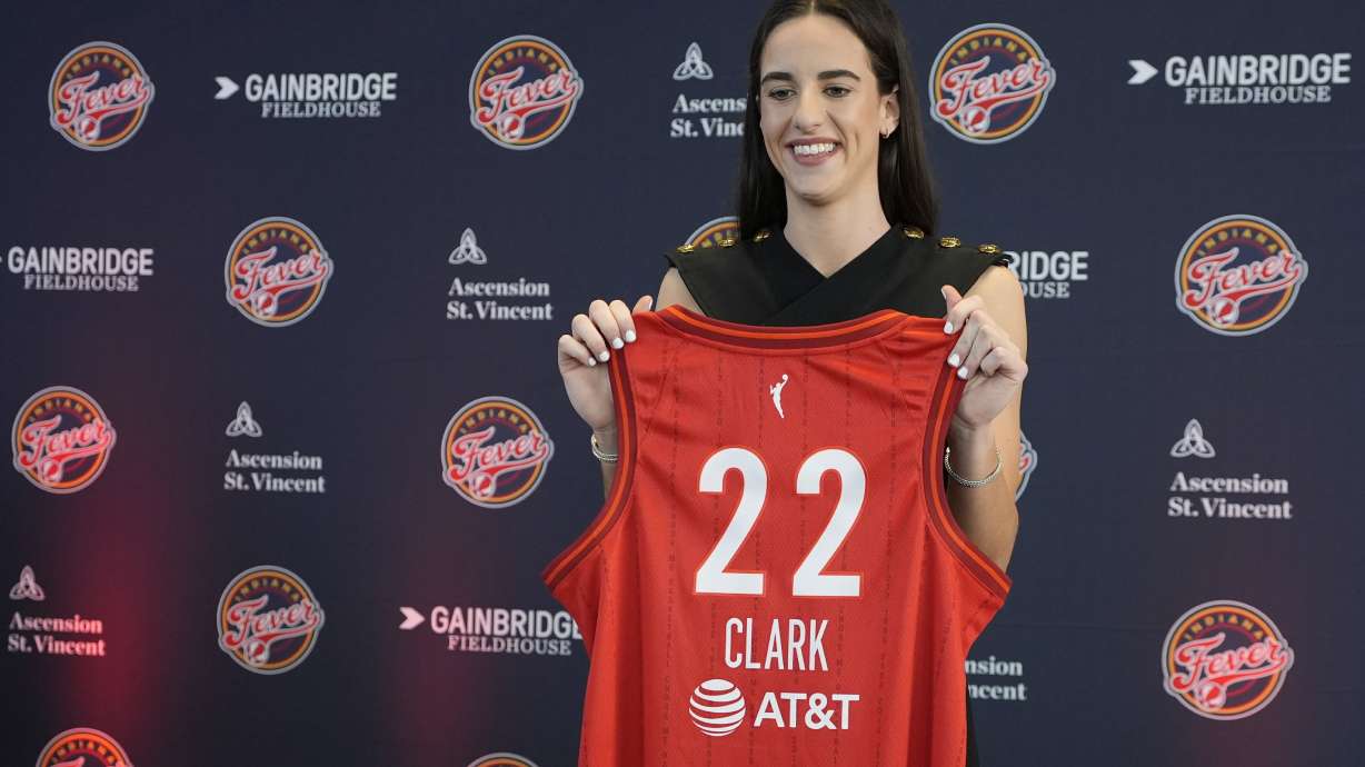 Indiana Fever's Caitlin Clark holds her jersey following a WNBA basketball news conference, Wednesday, April 17, 2024, in Indianapolis.