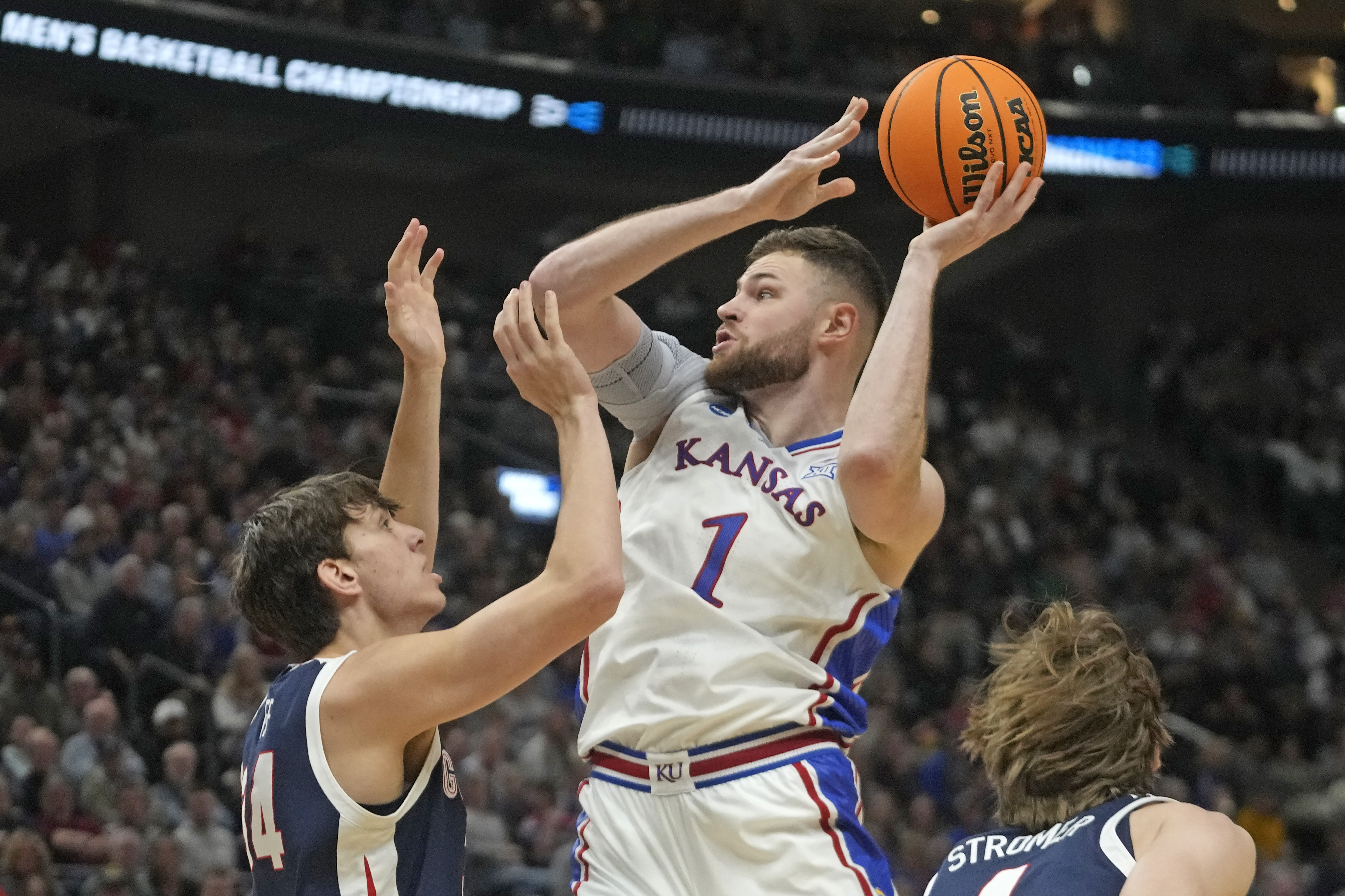 FILE - Kansas center Hunter Dickinson (1) shoots as Gonzaga forward Braden Huff (34) defends during the first half of a second-round college basketball game in the NCAA Tournament in Salt Lake City, Saturday, March 23, 2024. Kansas star center Hunter Dickinson on Friday, April 26, announced he would return for another season with the Jayhawks.