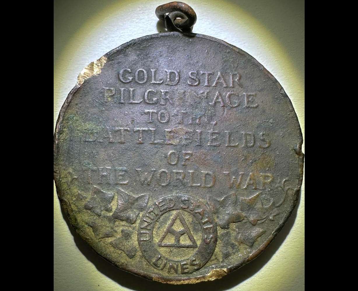 A fine bronze medallion produced by Tiffany & Company struck to honor the 1930 Gold Star Mothers and Widows Pilgrimage to the WWI battlefields of France. The medal features a raised, gold-plated star and is marked on the edge with a serial number. United States Steamship Line provided transport to France for thousands of mothers and widows, at the expense of the United States government, as an act of recognition and thanks for their sacrifice.