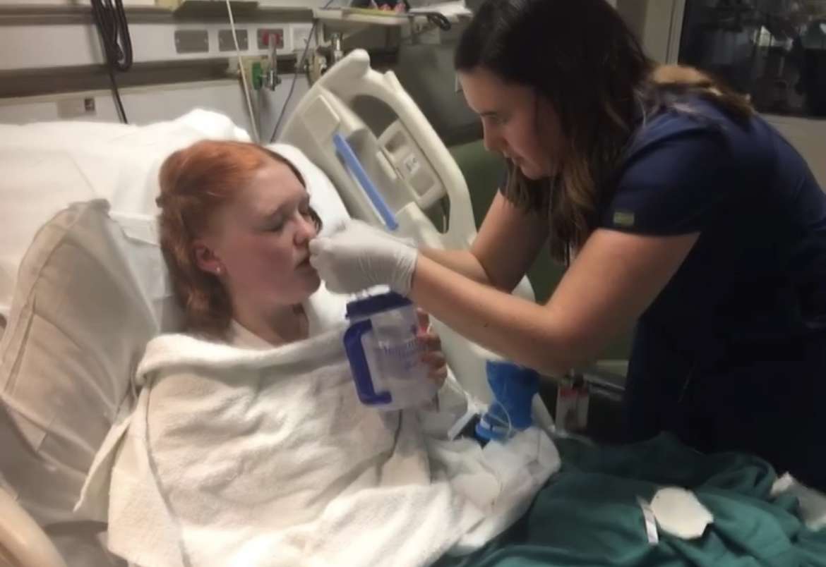 Hospital staff helping Gracelyn Wilkinson with drinking water while she was hospitalized.