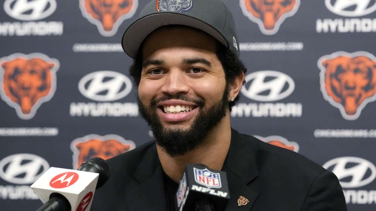 Chicago Bears No. 1 draft pick quarterback Caleb Williams smiles as he listens to reporters during an NFL football news conference in Lake Forest, Ill., Friday, April 26, 2024.