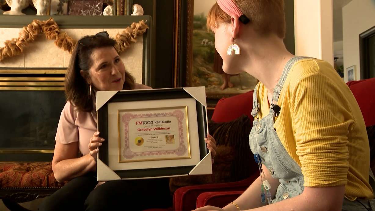 Rebecca Cressman presenting Gracelyn Wilkinson with her certificate of recognition.