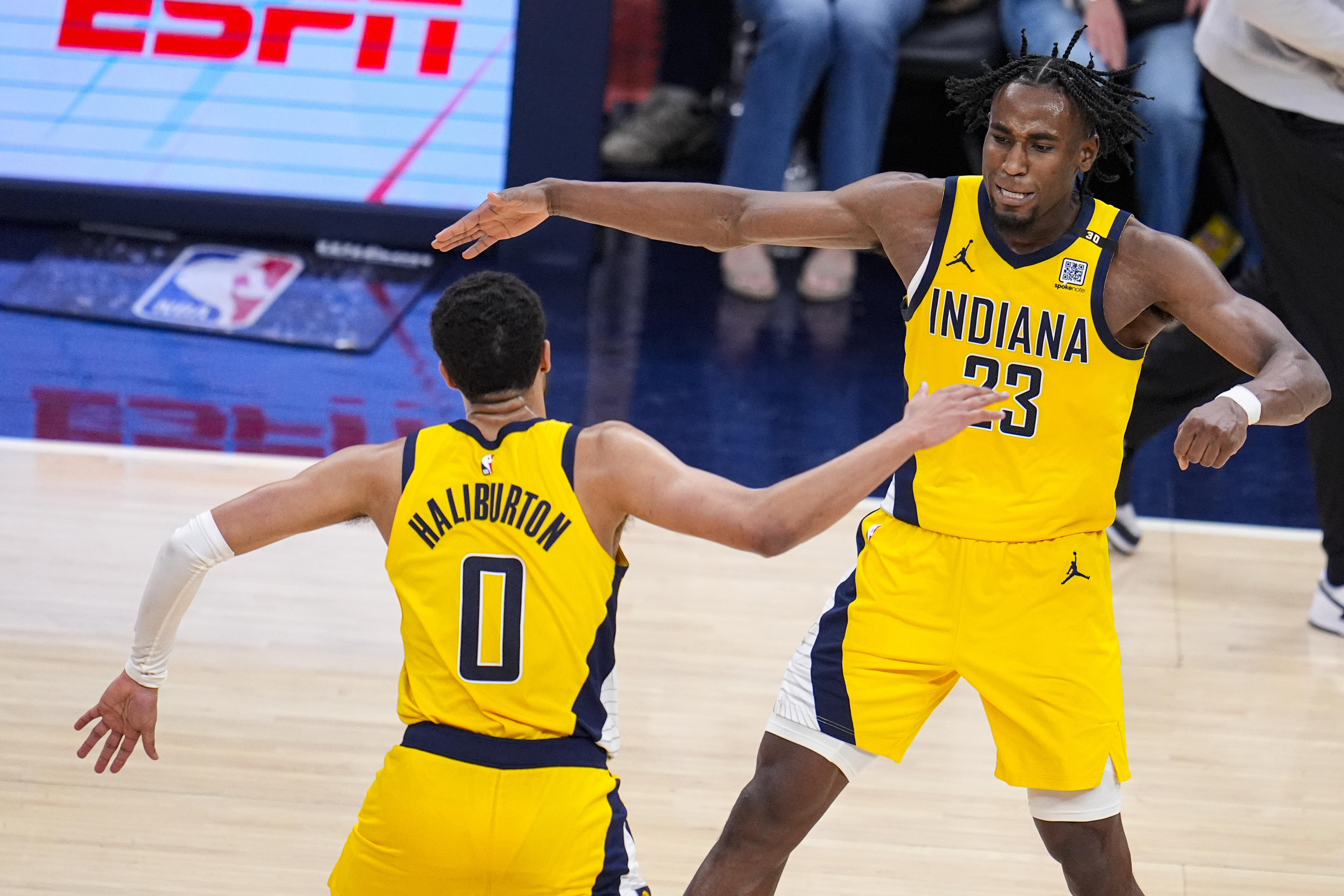 Indiana Pacers forward Aaron Nesmith (23) celebrates after a basket with Indiana Pacers guard Tyrese Haliburton (0) during overtime in Game 2 in an NBA basketball first-round playoff series, Friday, April 26, 2024, in Indianapolis.