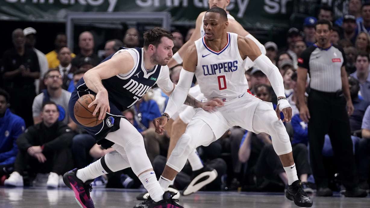 Dallas Mavericks guard Luka Doncic, left, works against Los Angeles Clippers guard Russell Westbrook (0) during the first half in Game 2 of an NBA basketball first-round playoff series in Dallas, Friday, April 26, 2024.