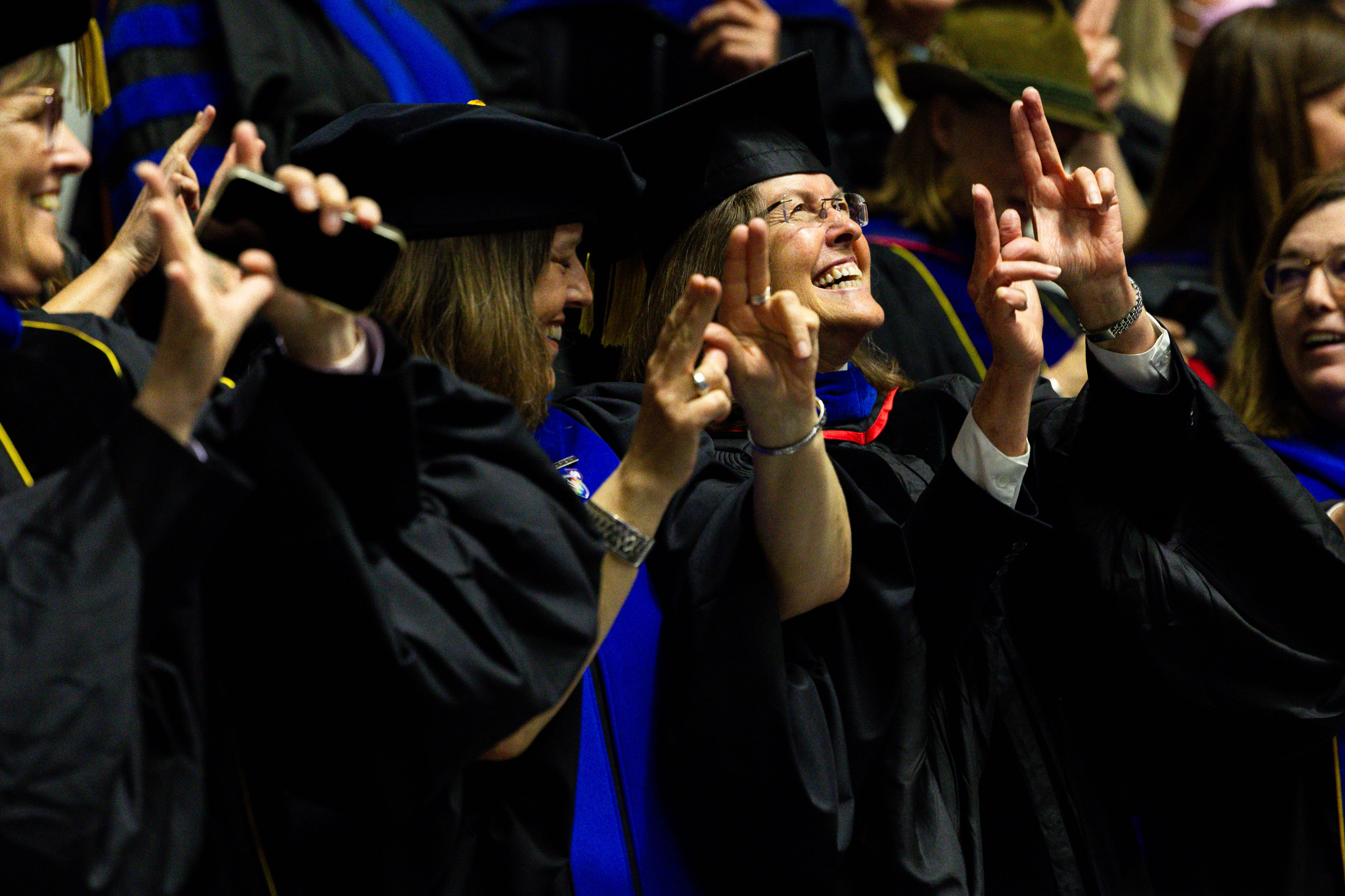 Faculty wave their hands as the graduates enter at Weber State University’s commencement program at the Dee Events Center in Ogden on Friday.