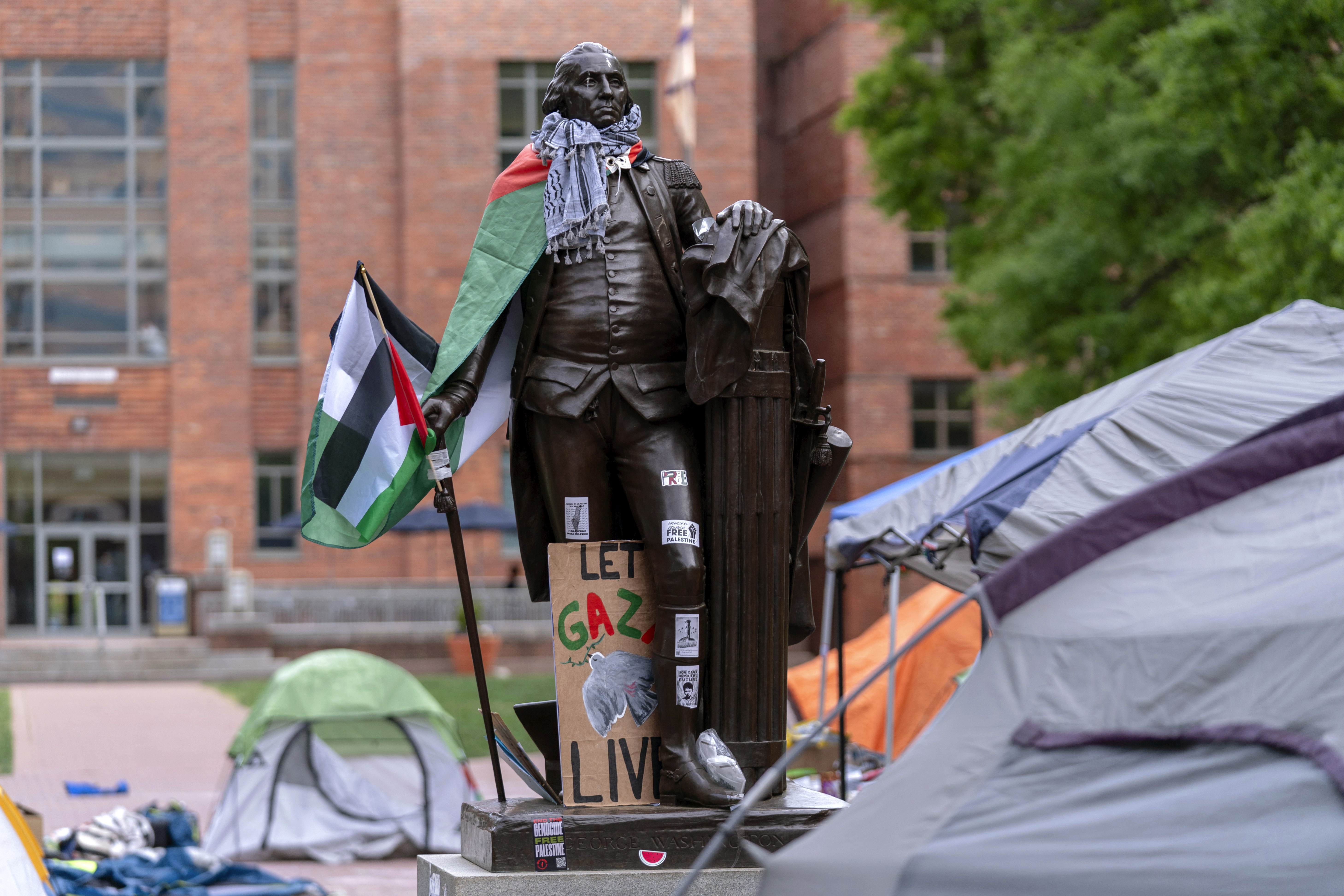 A statue of George Washington draped in a Palestinian flag and a keffiyeh is seen at George Washington University as students demonstrate on campus during a pro-Palestinian protest over the Israel-Hamas war on Friday, in Washington.