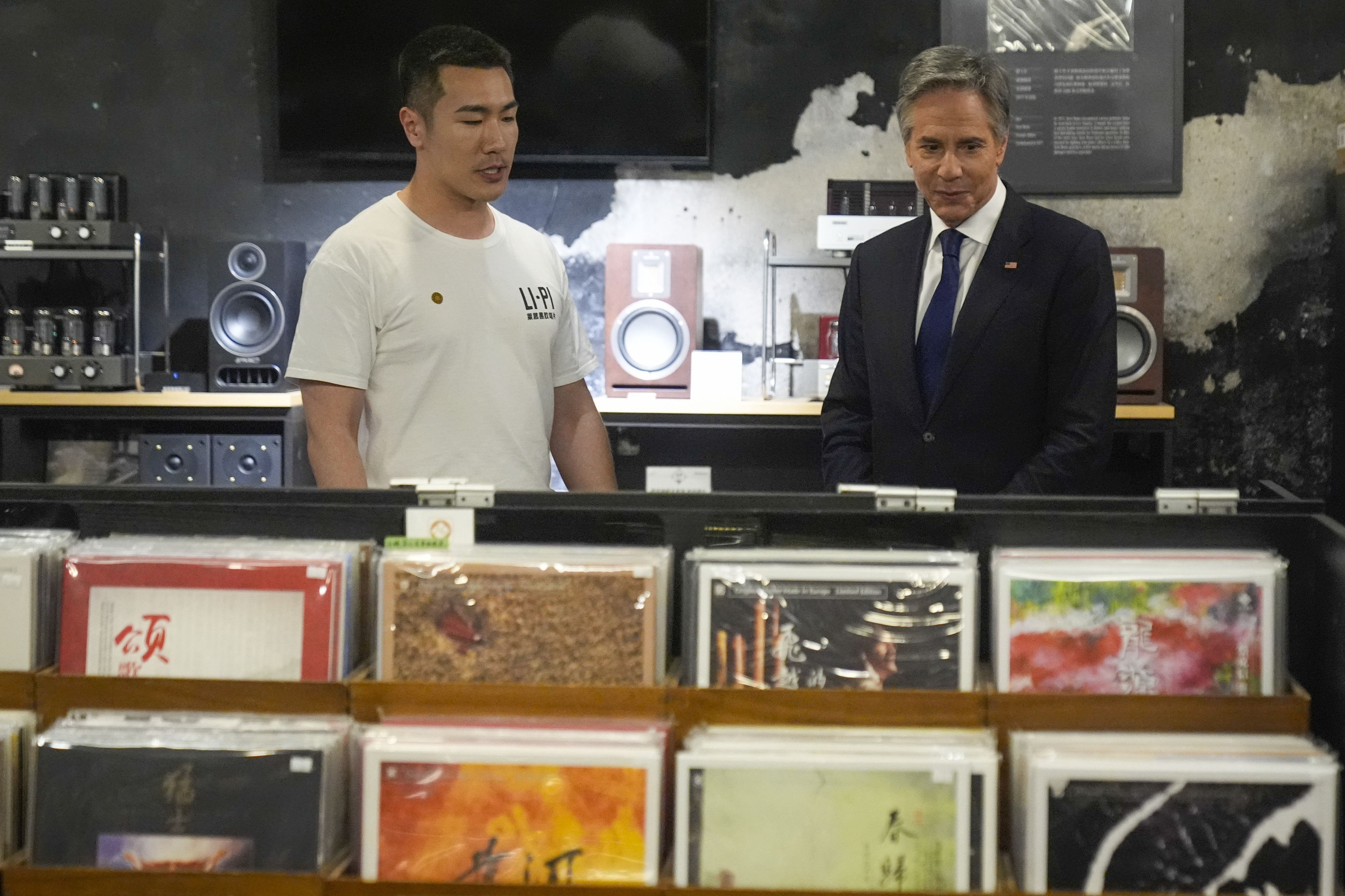U.S. Secretary of State Antony Blinken talks with Yuxuan Zhou during a visit to Li-Pi record store in Beijing on Friday.