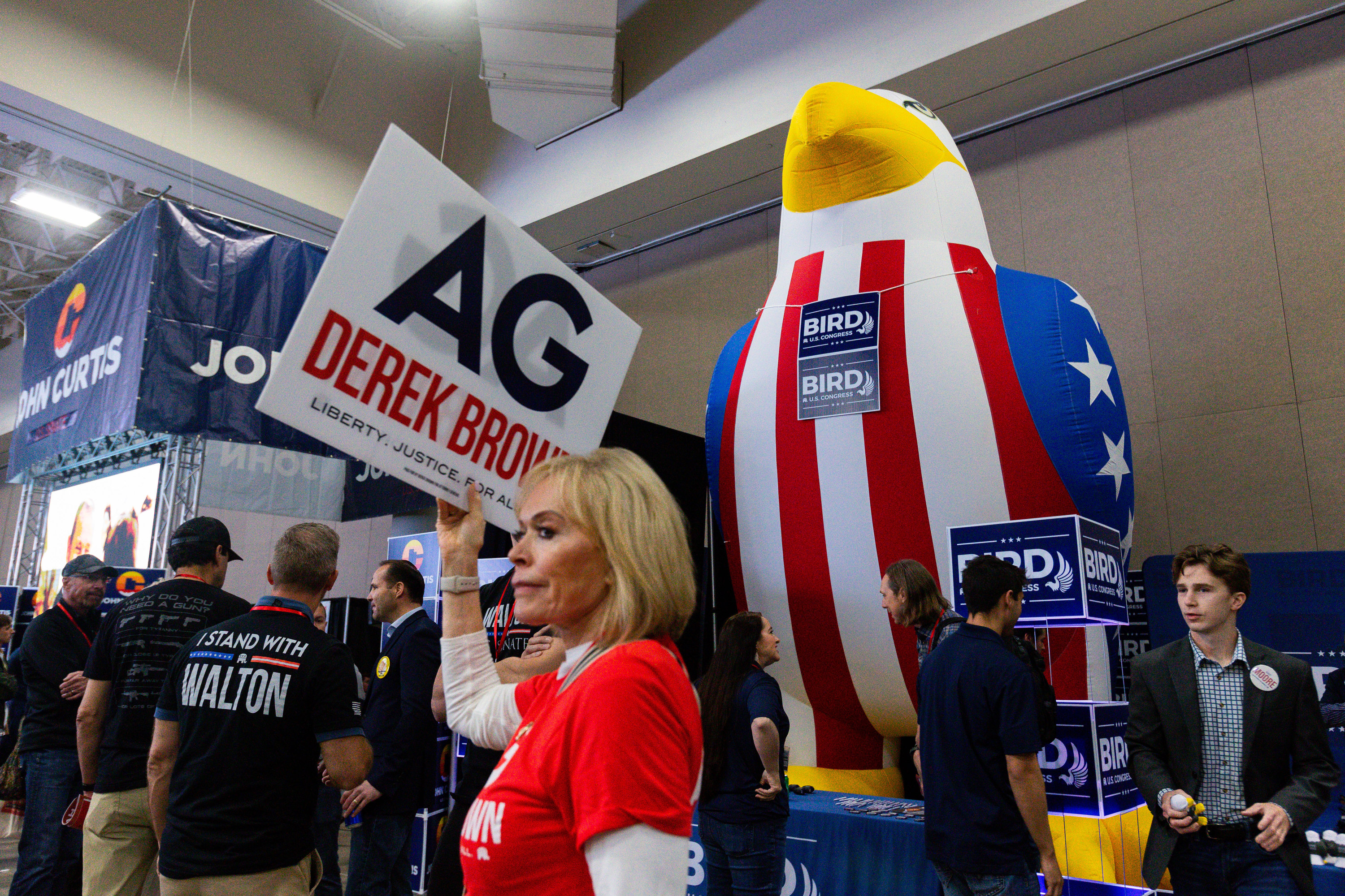 People campaign in the expo hall during the Utah Republican Party state nominating convention at the Salt Palace Convention Center in Salt Lake City on Saturday.