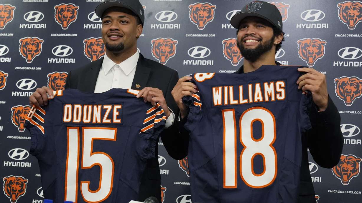 Chicago Bears No. 9 draft pick wide receiver Rome Odunze, left, and No. 1 draft pick quarterback Caleb Williams, right, hold up jerseys as they pose for a photo during an NFL football news conference in Lake Forest, Ill., Friday, April 26, 2024.