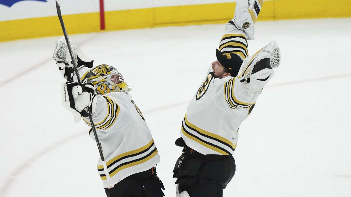 Boston Bruins goaltender Jeremy Swayman, left, and goaltender Linus Ullmark, right, celebrate after defeating the Toronto Maple Leafs in Game 4 of an NHL hockey Stanley Cup first-round playoff series in Toronto, Saturday, April 27, 2024.
