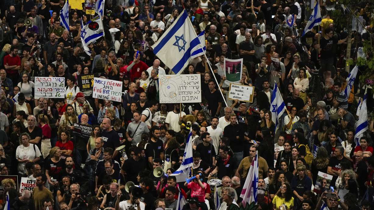 People protest against Israeli Prime Minister Benjamin Netanyahu's government and call for the release of hostages held in the Gaza Strip by the Hamas militant group in Tel Aviv, Israel, Saturday.
